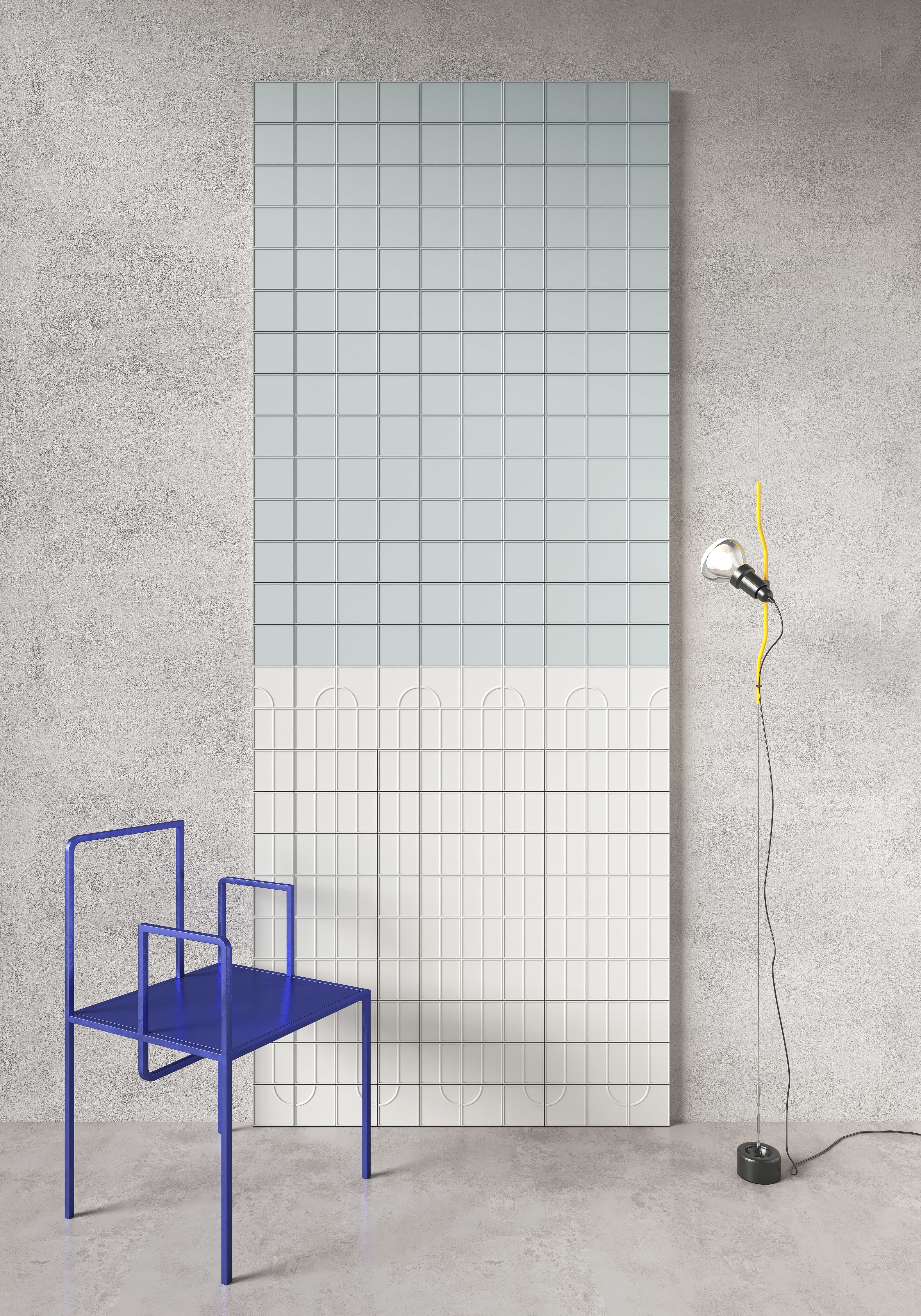 Micro Ways, by Terratinta — a two-tone feature wall, powder-blue squares above an ivory band of arch-relief tiles, styled with a cobalt chair.