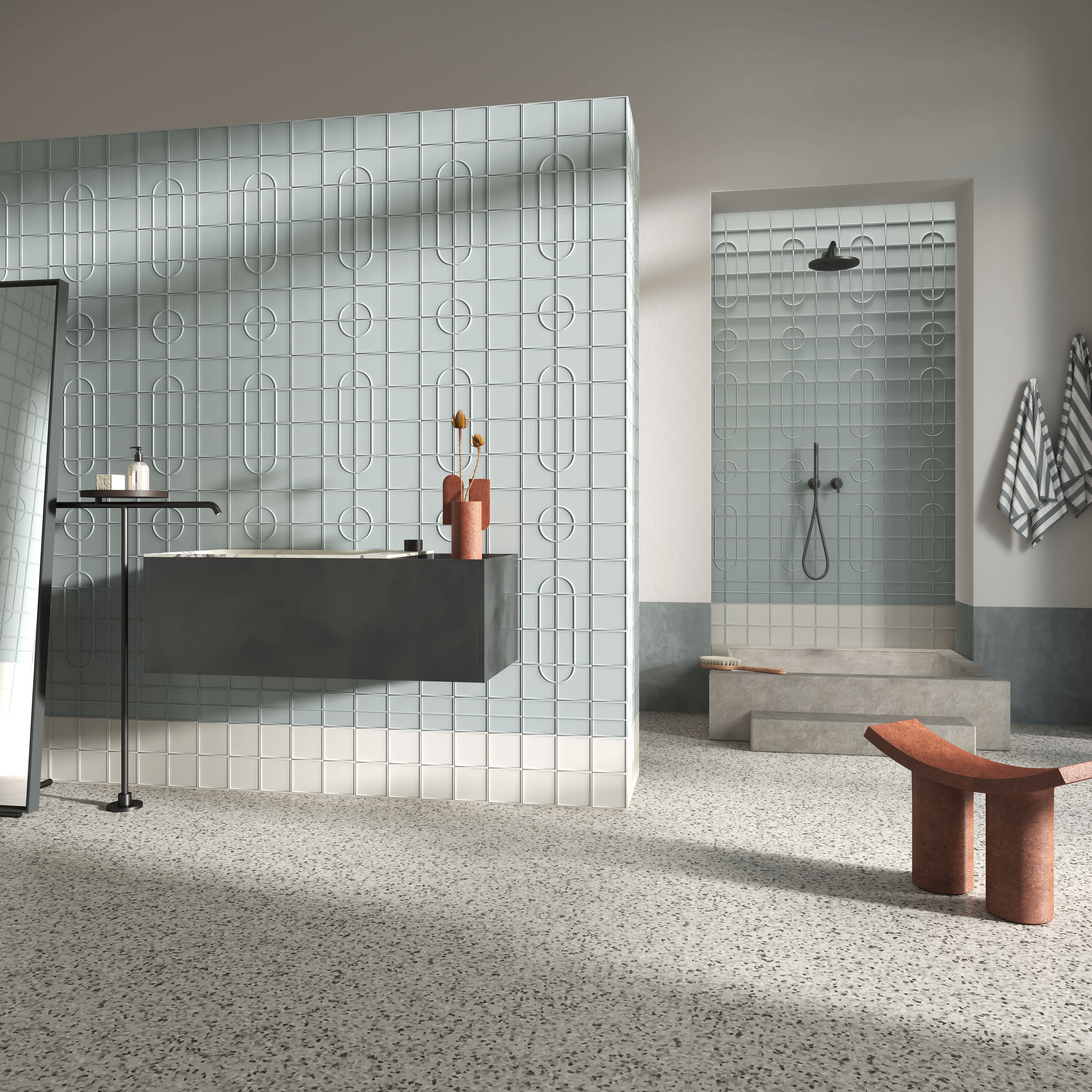 Micro Ways, by Terratinta — a spa-style bathroom, powder-blue oval-relief walls over a grey base with a black vanity and terrazzo floor.