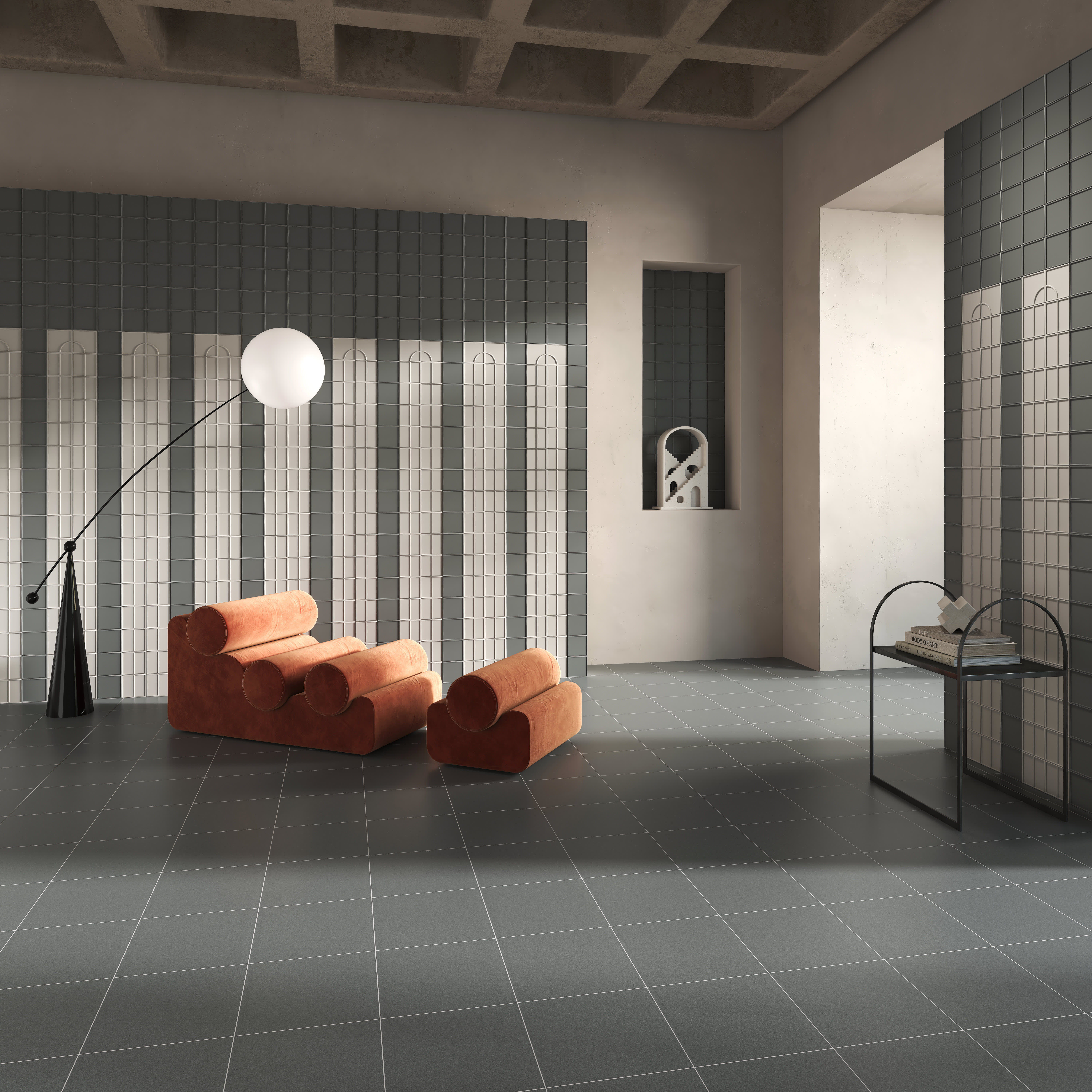 Micro Ways, by Terratinta — a grey vertical-relief feature wall in a gallery-like lounge, with burnt-orange seating.