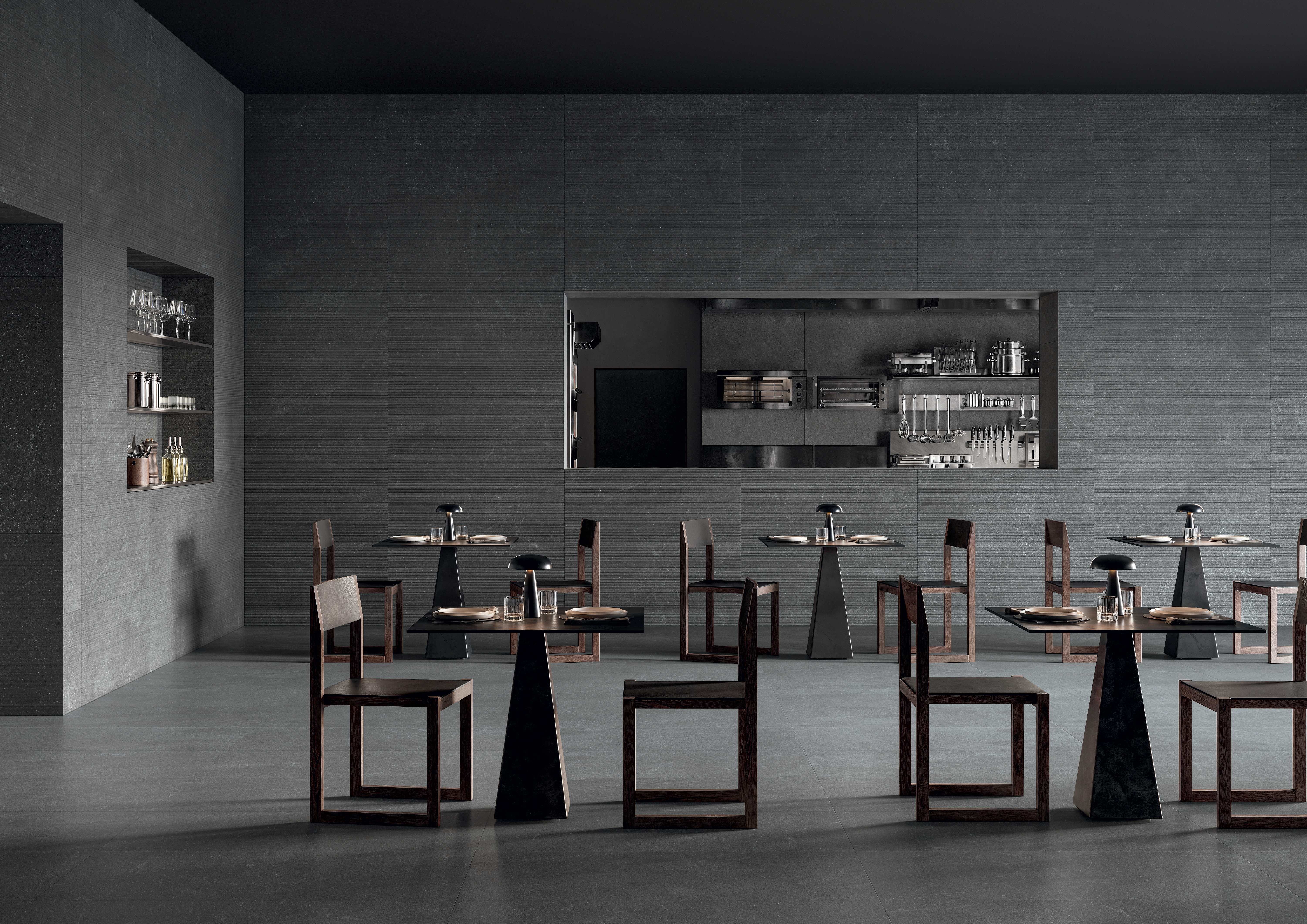 Restaurant interior in deep charcoal Natural porcelain with dining tables and a back bar.