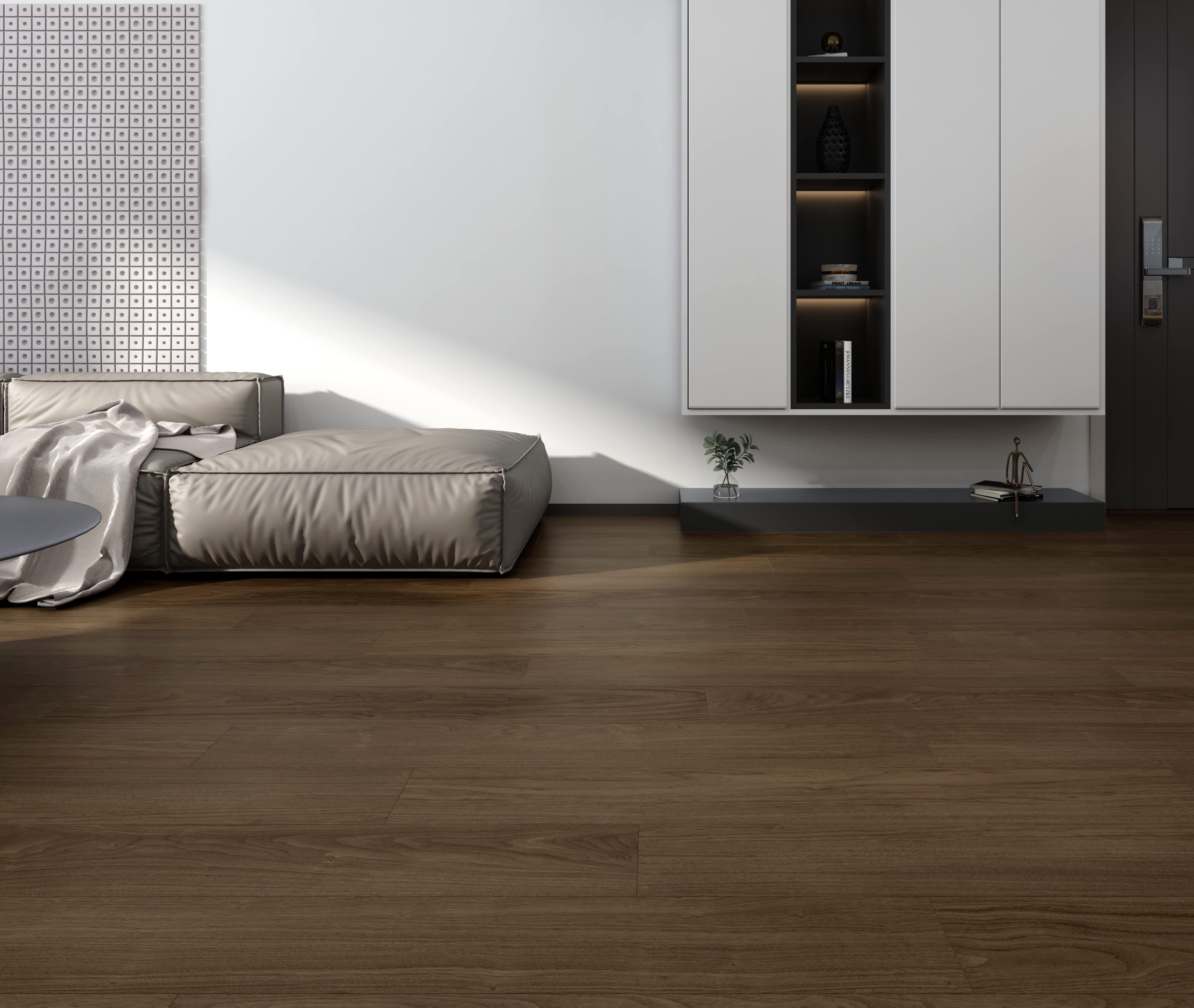 Port vinyl flooring in Mast, warm chocolate-brown wood-look planks in a minimal living room with a low grey sofa