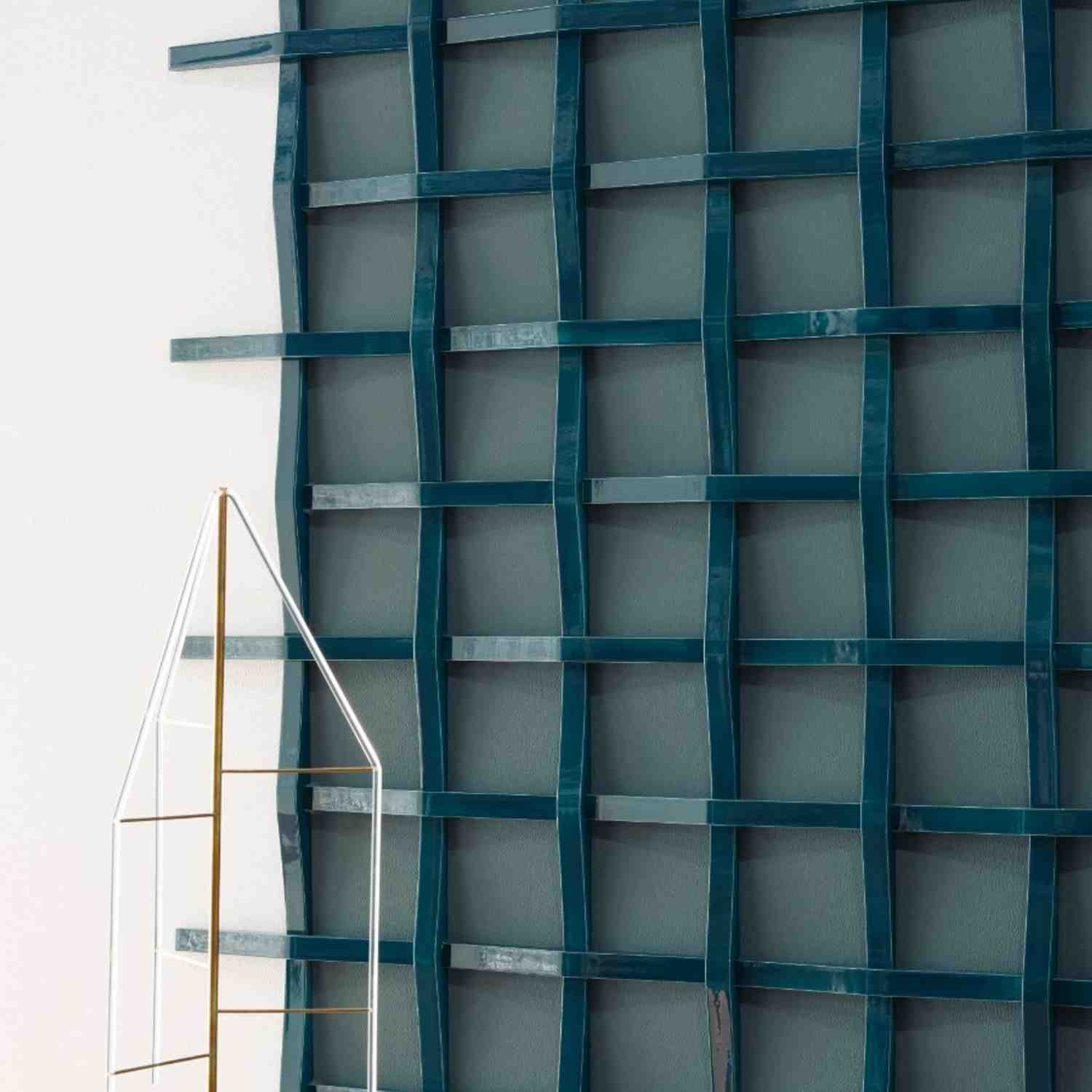 Mutina Adagio blu glossy ceramic wall tile installation with woven grid relief pattern in deep blue