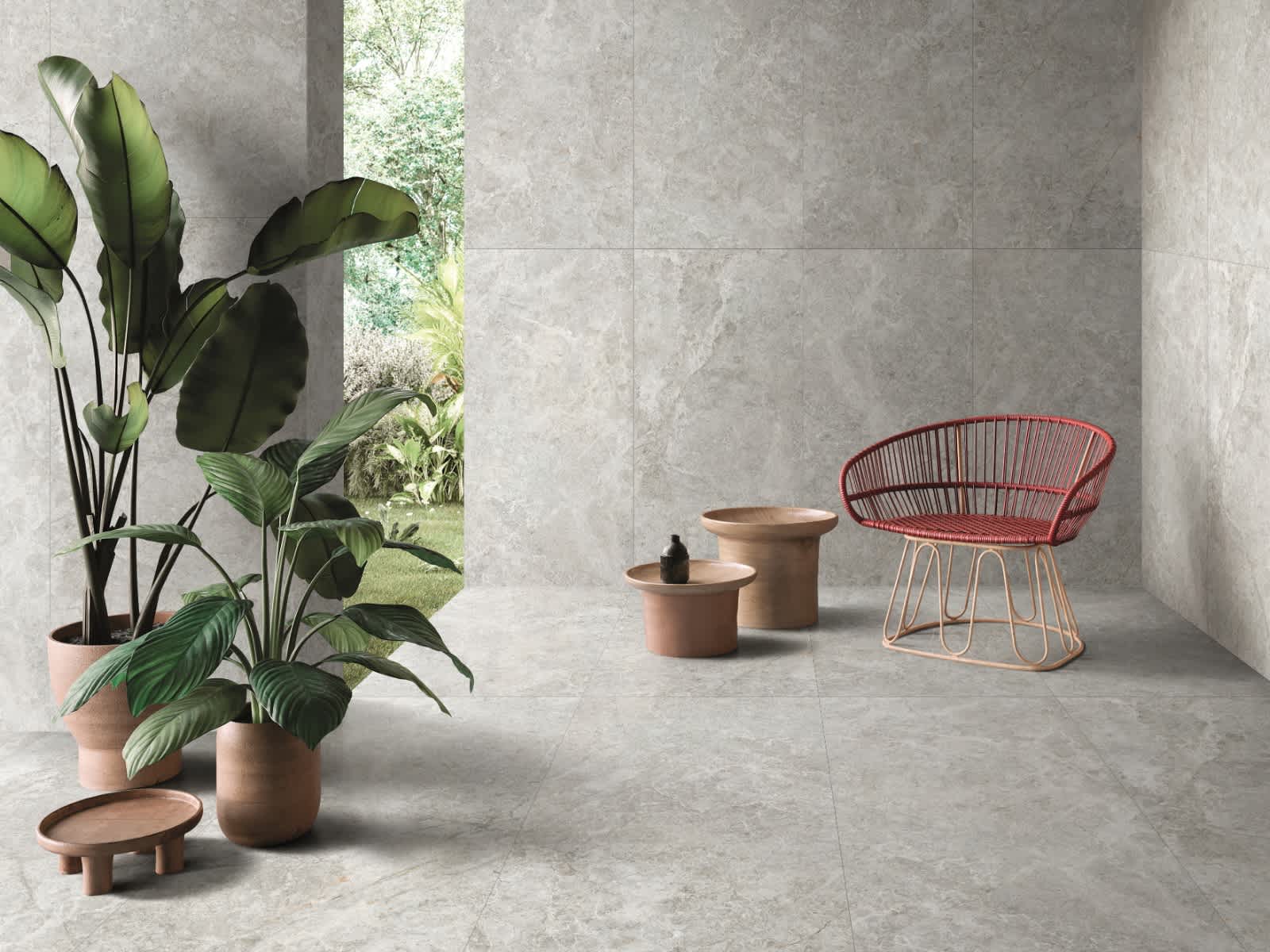 Max Glory Antalya Bianco glazed porcelain tile minimalist space with stone-look wall and floor tiles tropical plants terracotta side tables and coral wire accent chair