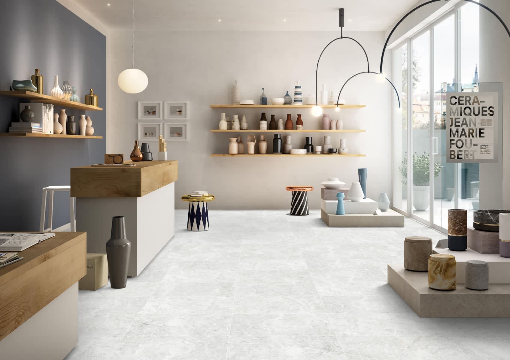 Max Glory Antalya Bianco glazed porcelain tile ceramics gallery showroom with light stone-look floor tiles wooden shelving pottery displays pendant lights and storefront windows