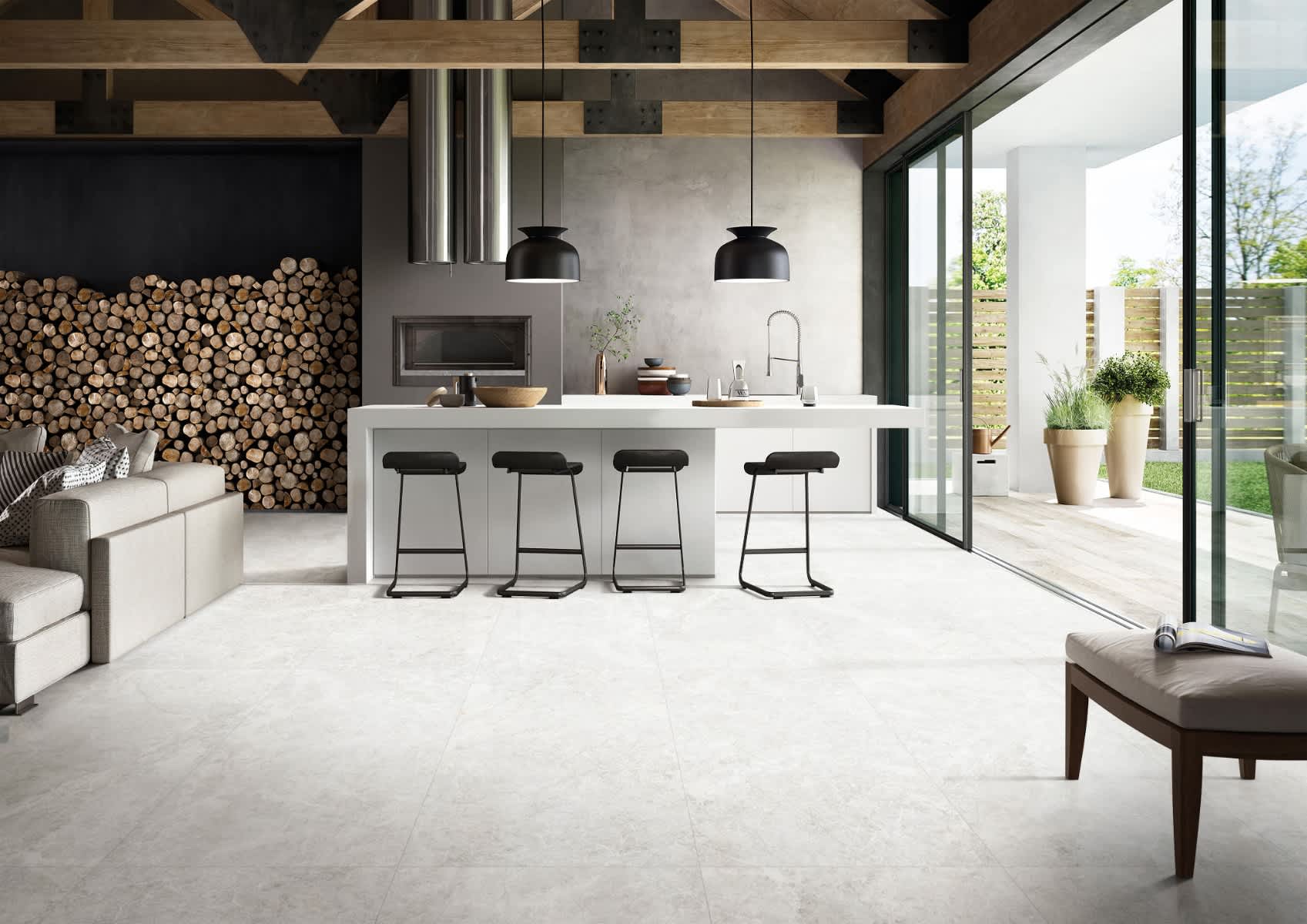 Max Glory Antalya Bianco glazed porcelain tile open-concept kitchen with light stone-look floor white island black bar stools stacked firewood wall exposed beam ceiling and garden view