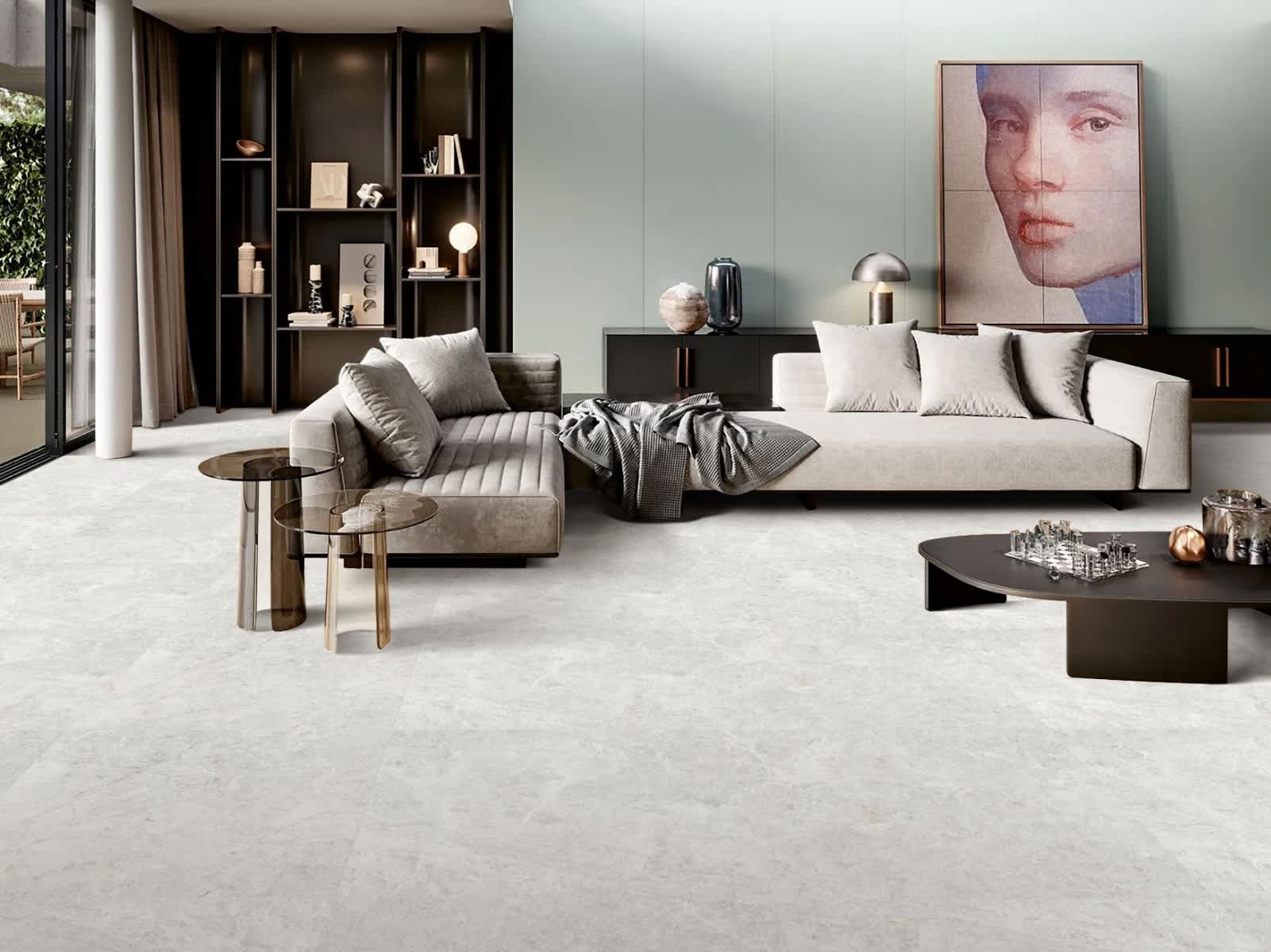 Max Glory Antalya glazed porcelain tile modern living room with light stone-look floor tiles cream sectional sofa dark built-in bookshelf and contemporary artwork