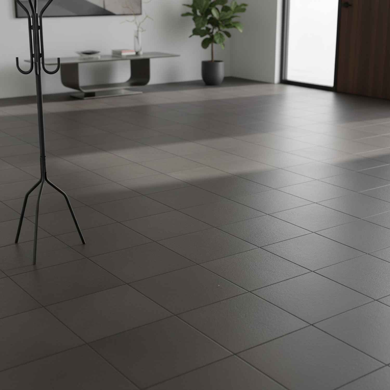 Mutina Aurore Charcoal glazed porcelain stoneware living space with dark plain floor tiles black metal coat stand and modern coffee table with plant