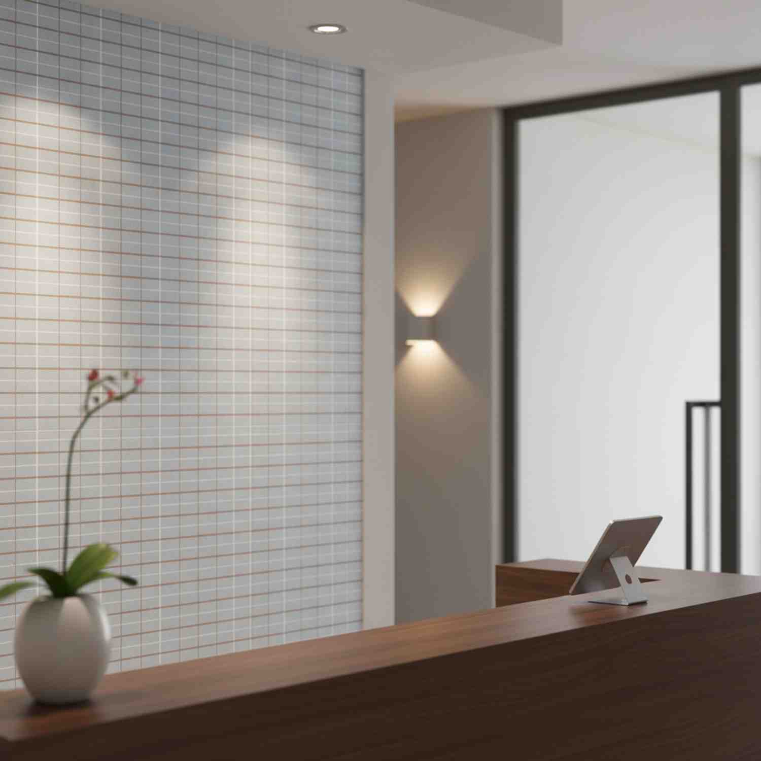 Mutina Aurore Light Green glazed porcelain stoneware grid tile wall detail with natural light cherry blossom branch warm wall sconce and modern hallway