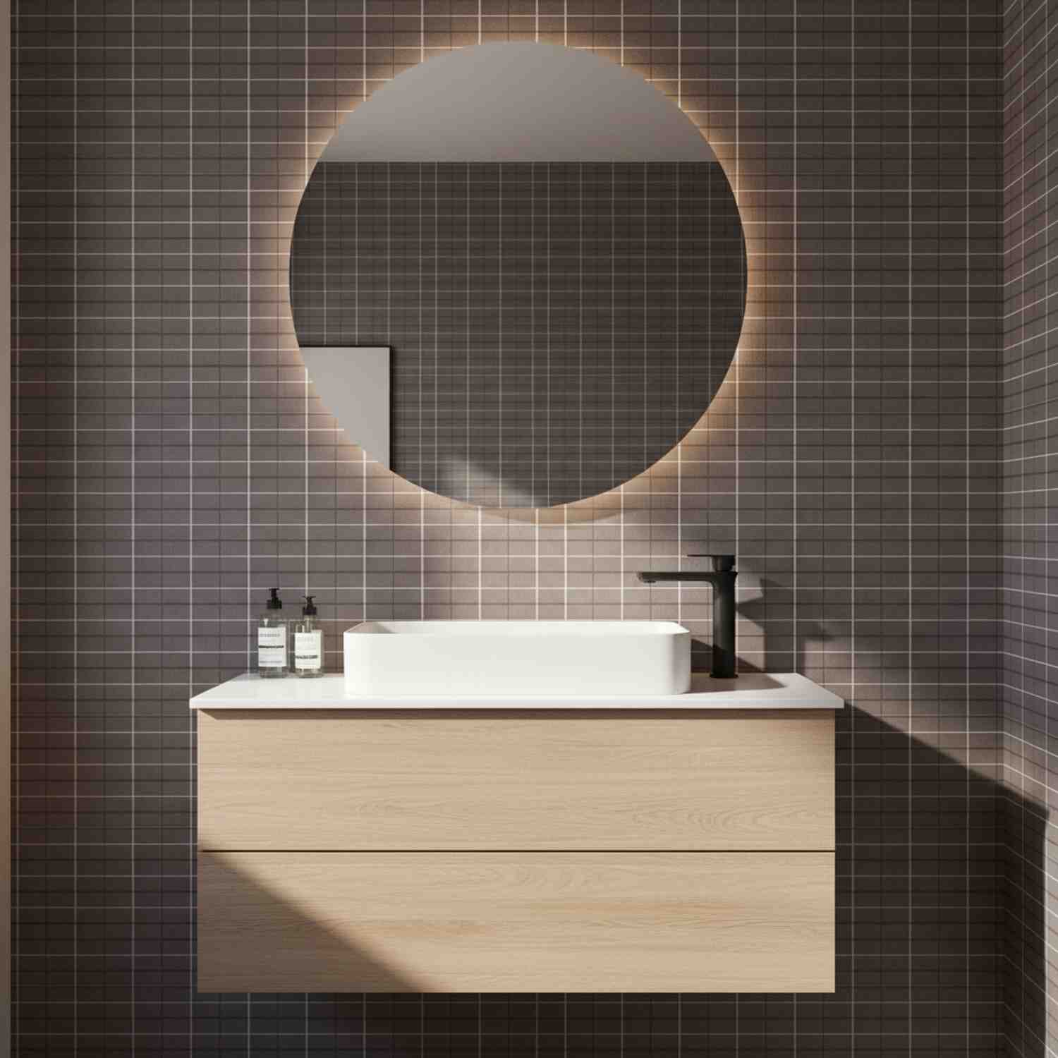 Mutina Aurore Charcoal glazed porcelain stoneware bathroom close-up with grid tile wall large round backlit mirror white vessel sink black faucet and oak floating vanity
