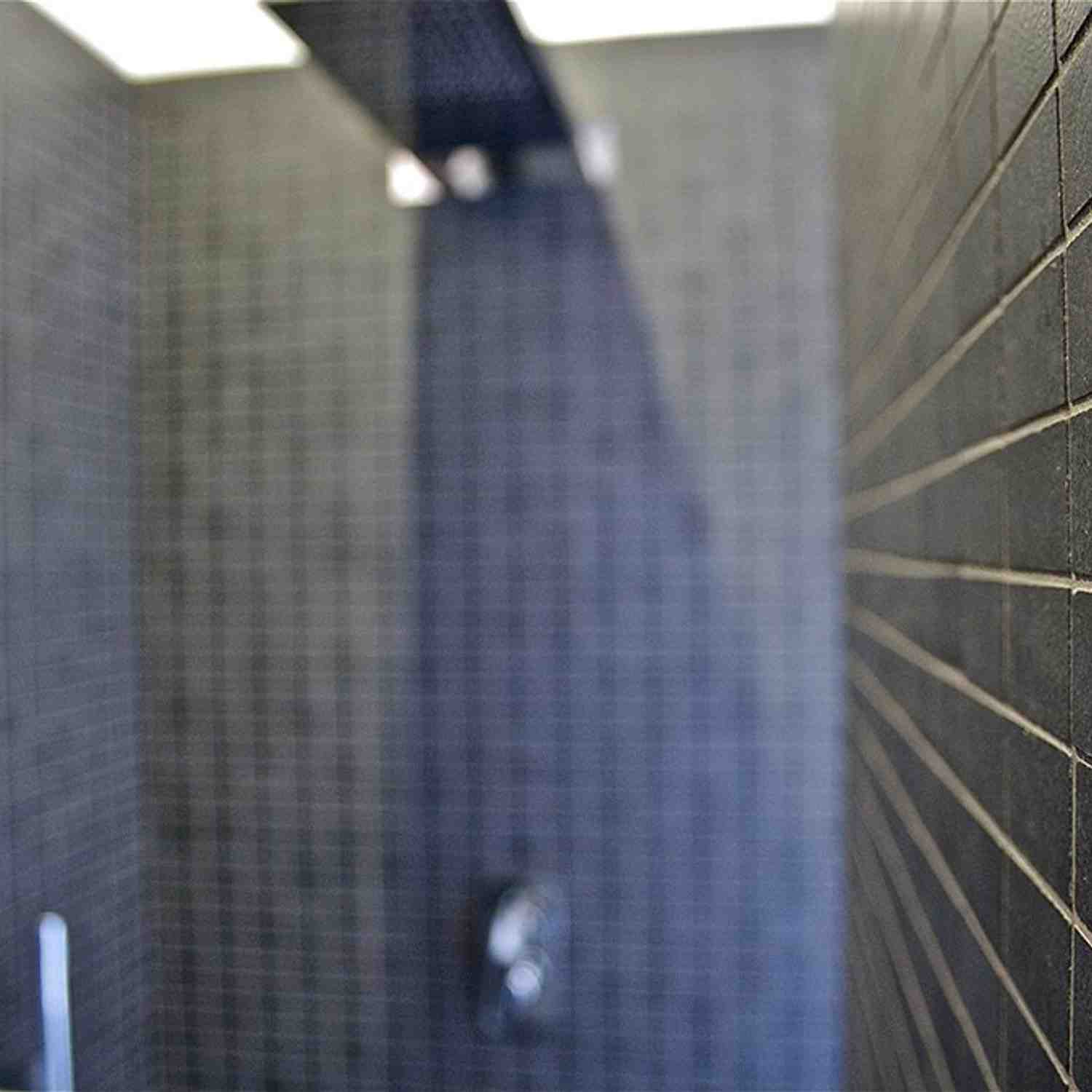 Terratinta Betontech Grey full-body porcelain stoneware wall tile in modern shower with glass door and concrete-look matte finish