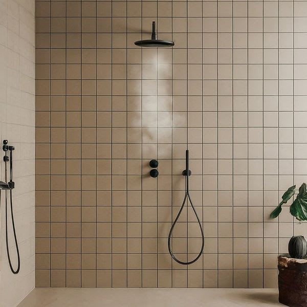 Cesi glazed porcelain stoneware wall tiles in blush pink matte finish in modern shower with matte black rain shower head handheld shower fixtures and tropical plant