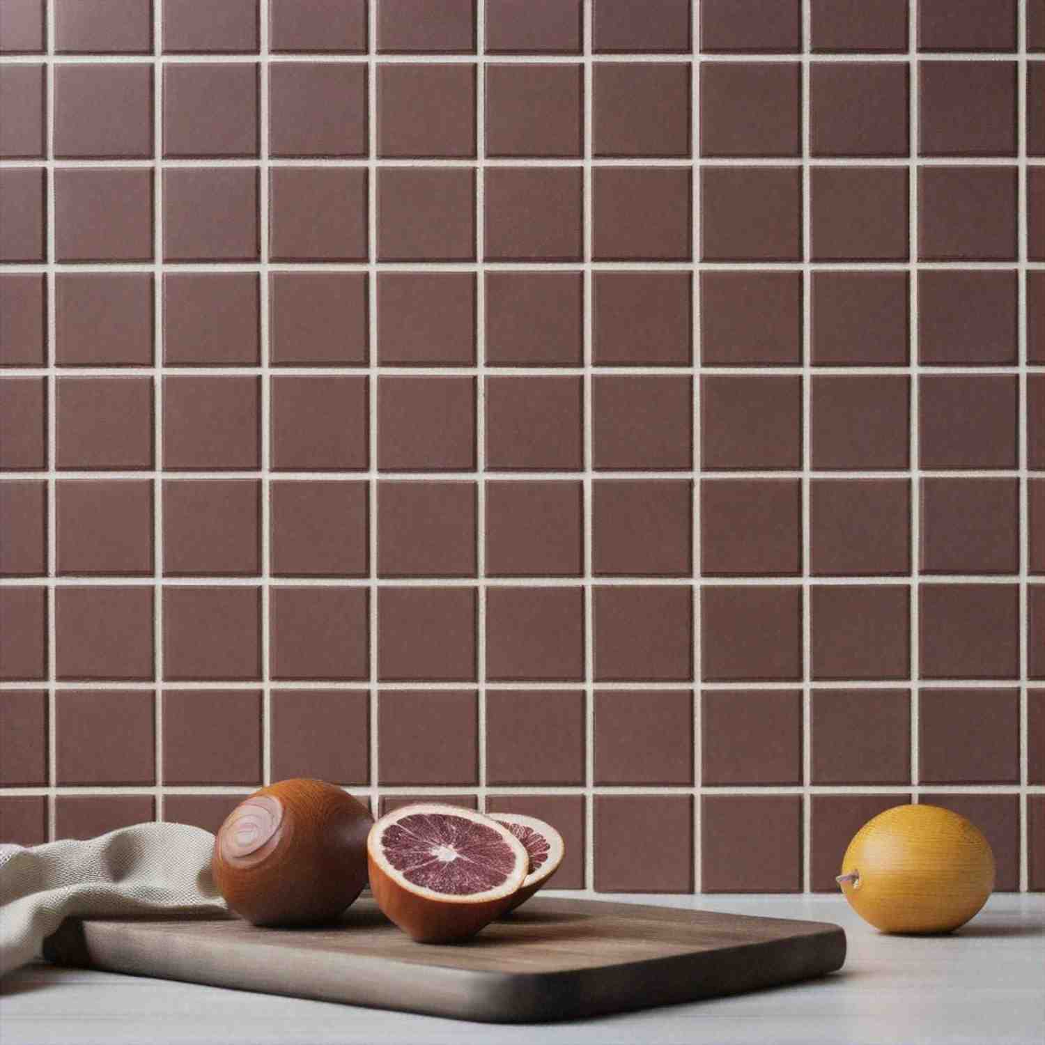 Cesi Gres glazed porcelain stoneware tiles close-up in warm brown terracotta color arranged in grid pattern with white grout lines showing matte finish surface texture