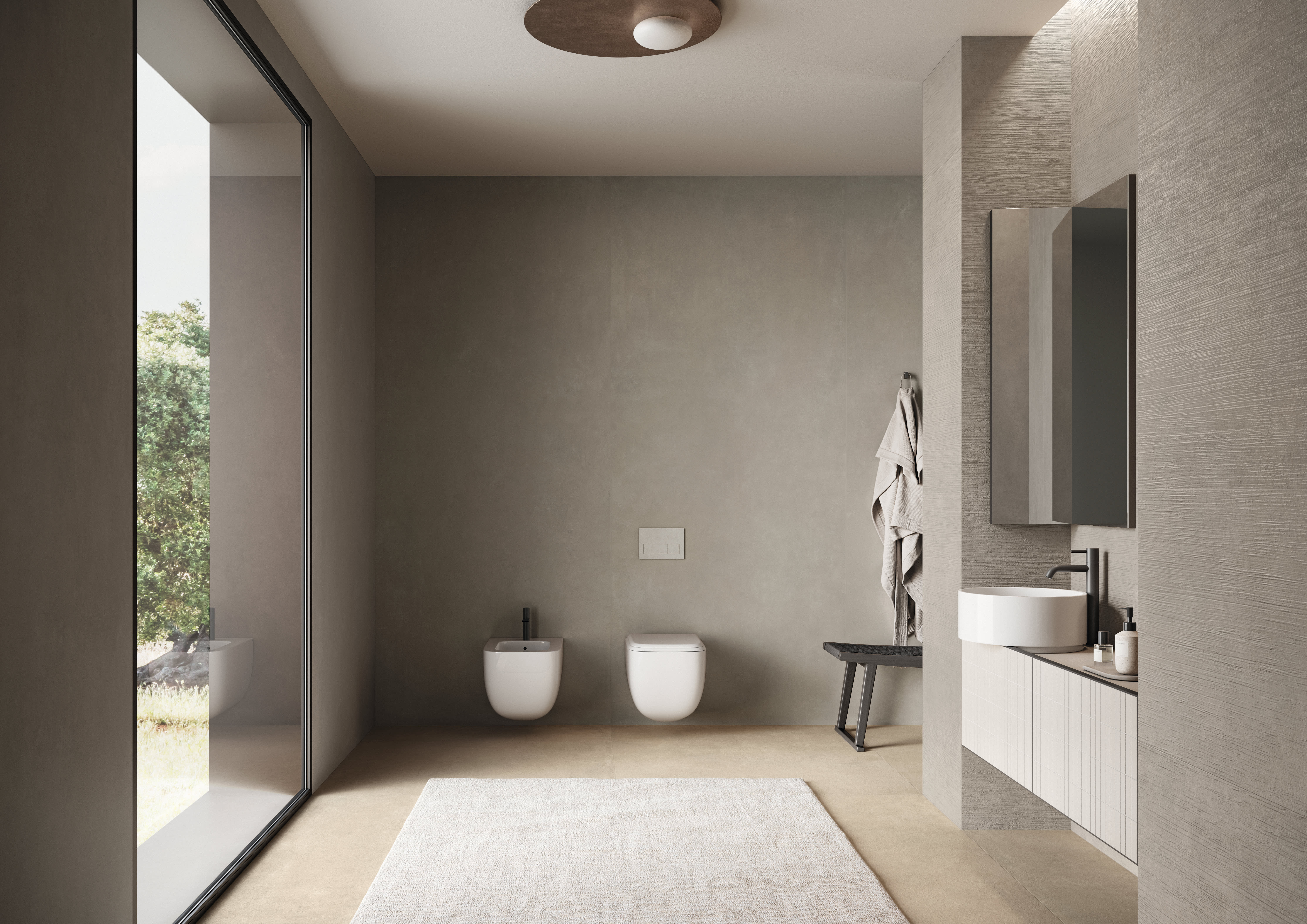Concrete porcelain tile lining a warm greige bathroom, with large-format walls and floor, a wall-hung toilet and bidet, a floating vanity and a garden view.