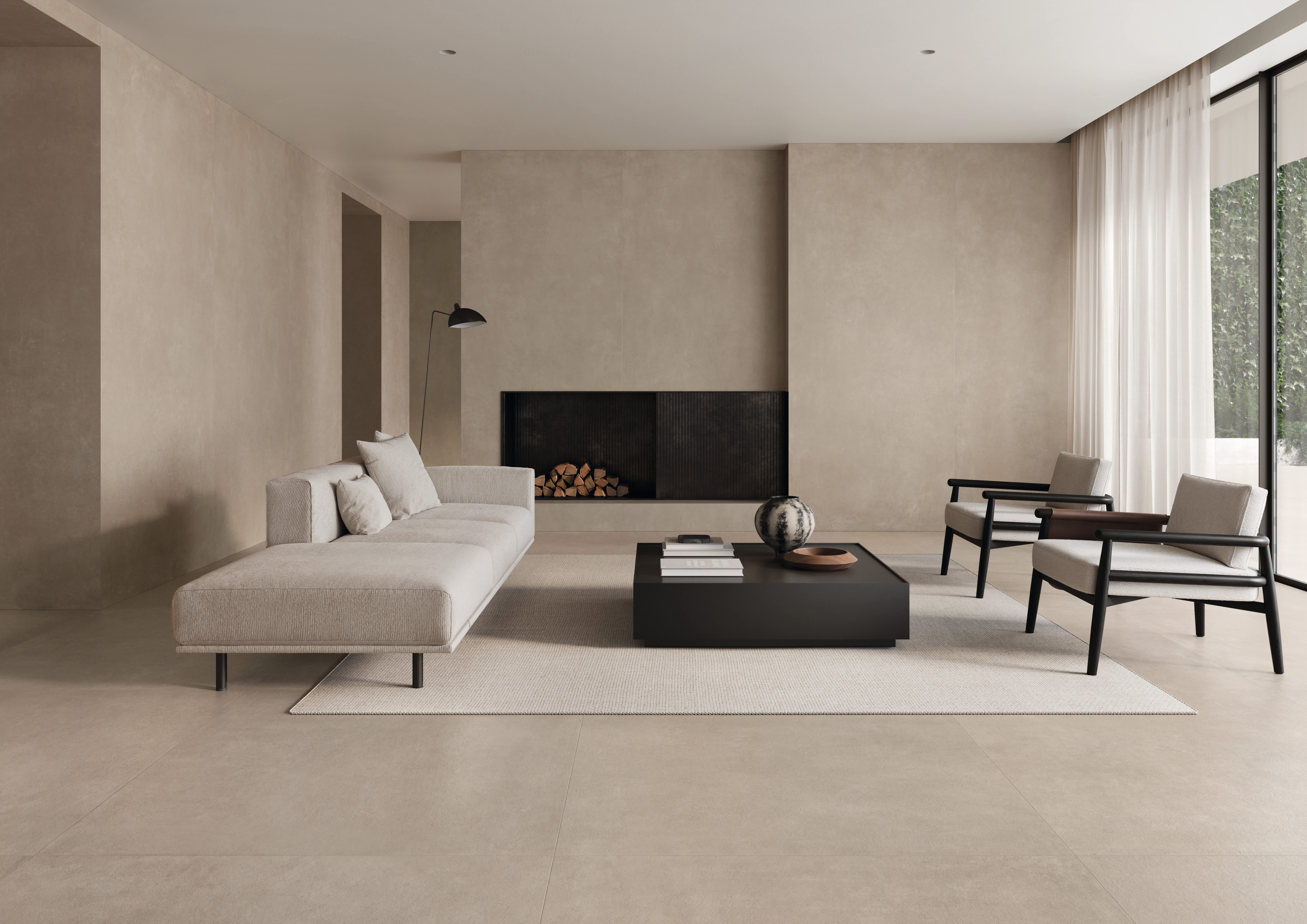 Concrete porcelain tile in a warm greige living room, large-format walls and floor with a low sofa, a built-in fireplace and lounge chairs.