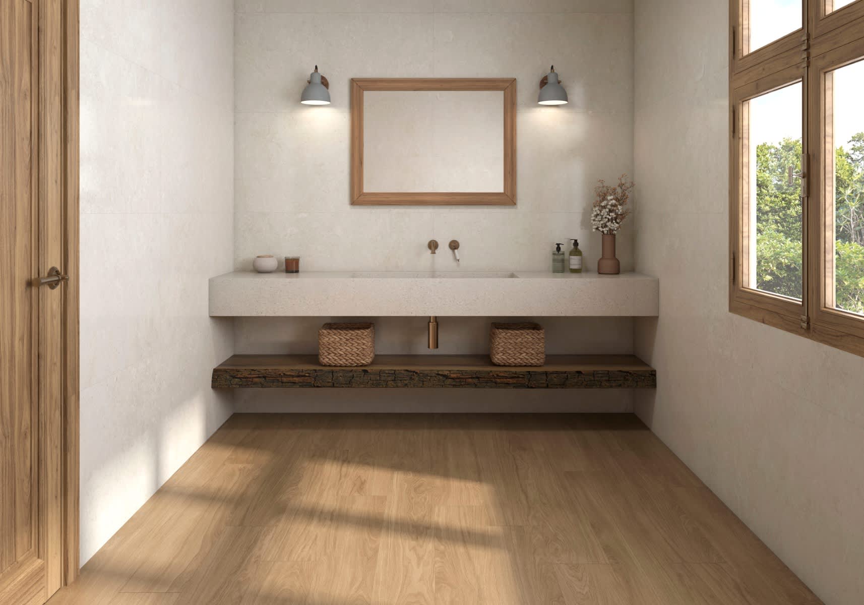 Pamesa Coralstone porcelain stoneware mosaic wall tiles in warm beige cream coral stone finish installed in bathroom with floating concrete vanity wooden framed mirror grey wall sconces brass faucet woven baskets decorative vases wooden flooring and garde