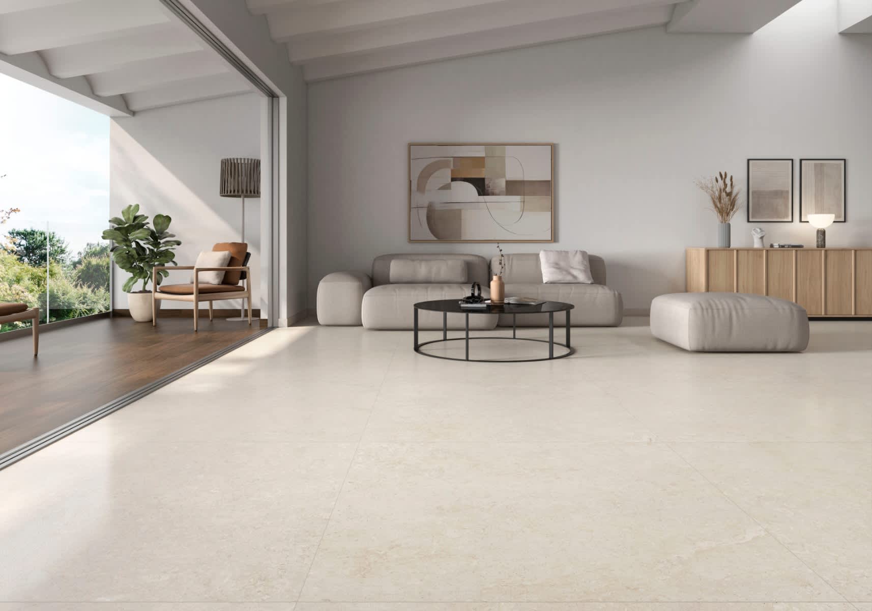 Pamesa Coralstone porcelain stoneware mosaic floor tiles in warm beige cream coral stone finish installed in modern living room with grey modular sofa white cushions black round metal coffee table abstract geometric wall art mid-century accent chair with