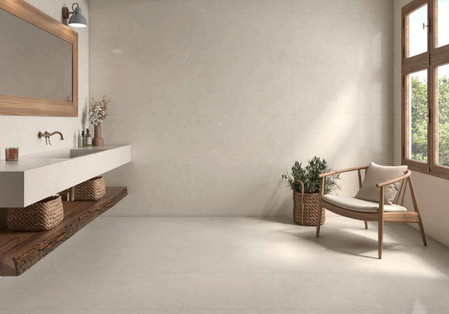 Pamesa Coralstone porcelain stoneware mosaic wall and floor tiles in warm beige cream coral stone finish installed in minimalist bathroom with white floating vanity wooden framed mirror grey pendant light brass faucet dried flower arrangement mid-century