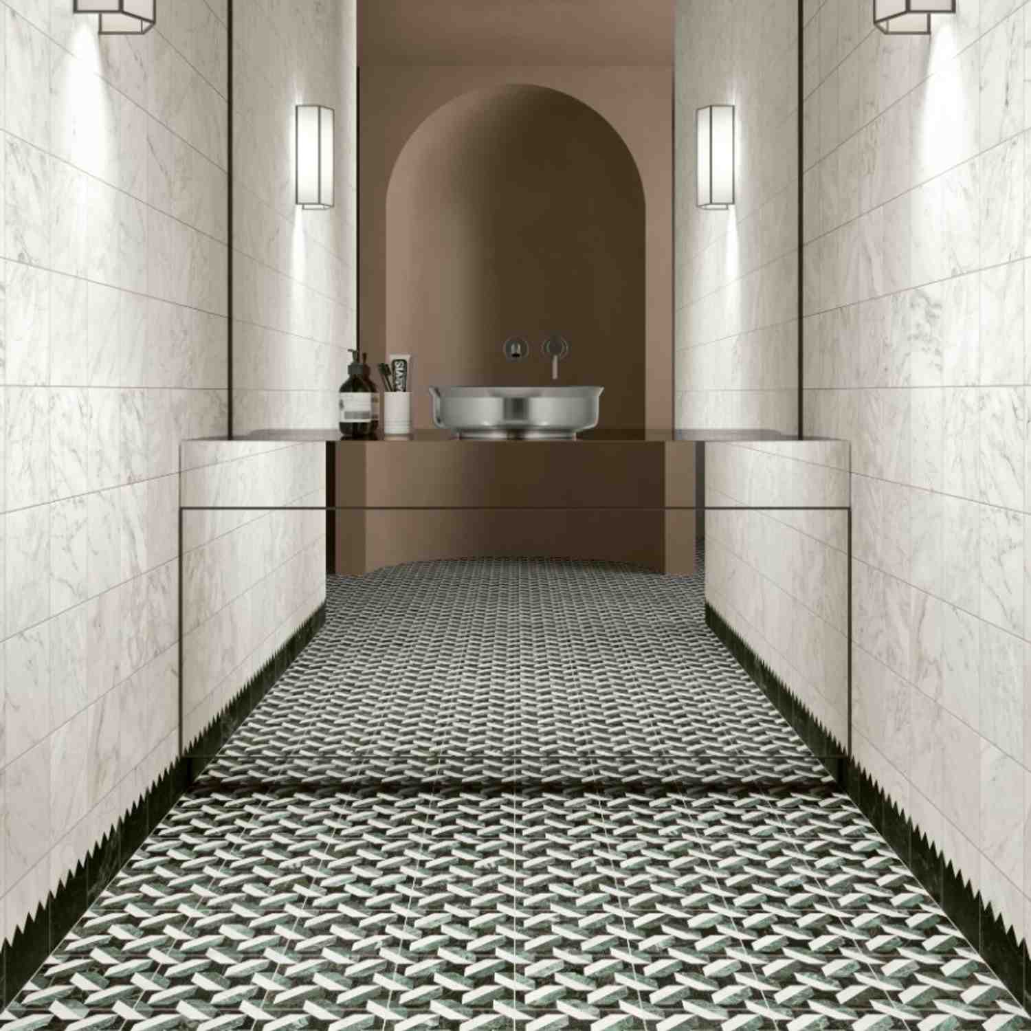 41zero42 Dandy glazed porcelain stoneware white marble vertical strip wall tiles and green white geometric pin pattern floor tiles in luxury bathroom with arched niche metallic vessel sink wooden vanity wall-mounted faucet wall sconces and bath accessorie