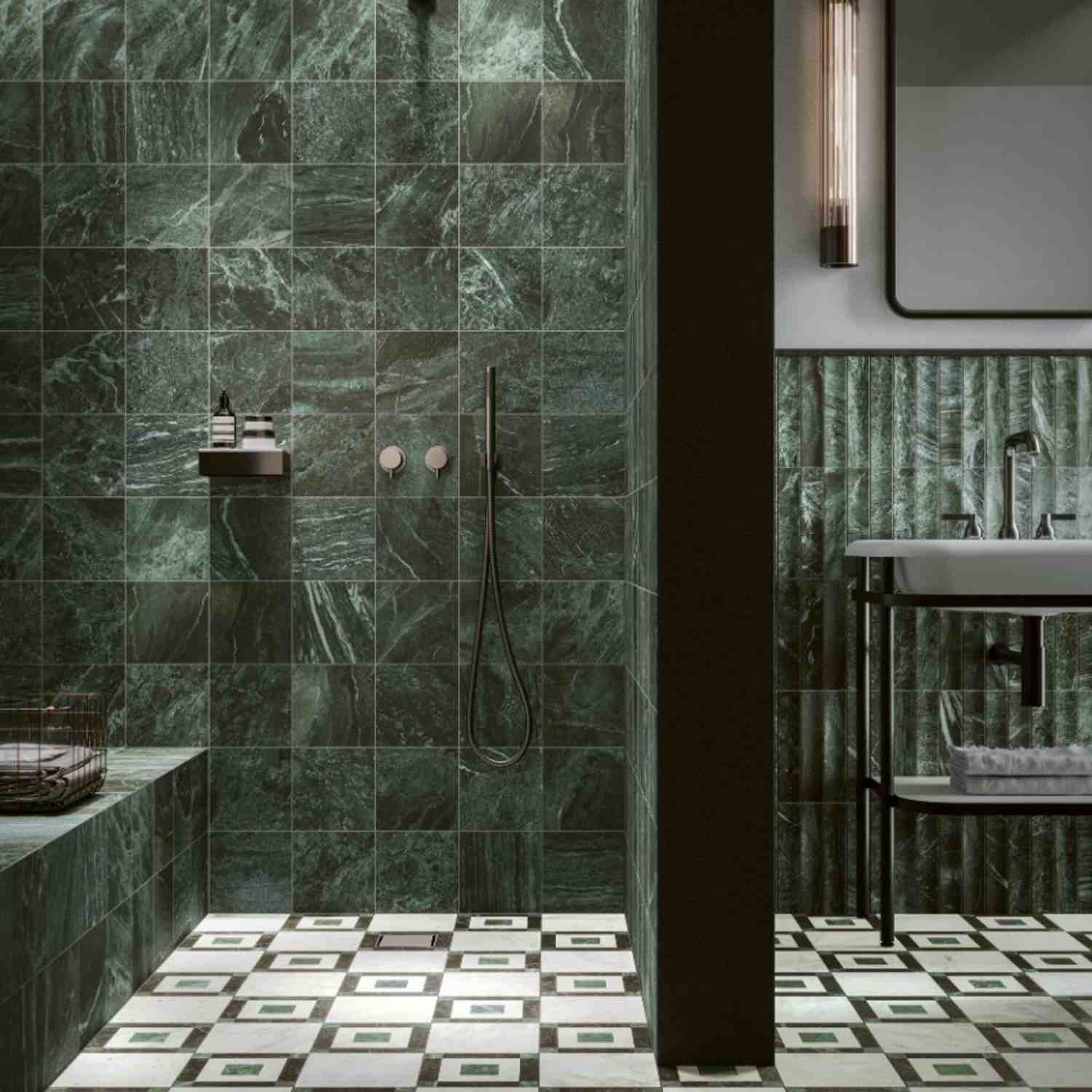 41zero42 Dandy glazed porcelain stoneware dark green marble-look wall tiles in luxury bathroom with walk-in shower bronze wall-mounted fixtures handheld shower and adjacent vanity area with dark green vertical strip tiles marble countertop modern pendant