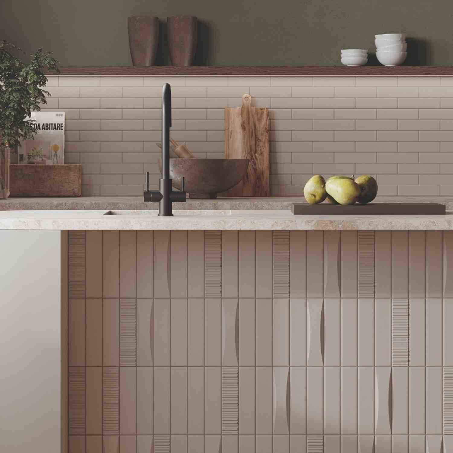 Elios Dust matte ceramic tiles in ice cream horizontal backsplash and dove vertical lower wall installed in rustic kitchen with black faucet wooden cutting boards copper bowl pears on serving board and open shelving with pottery and white bowls