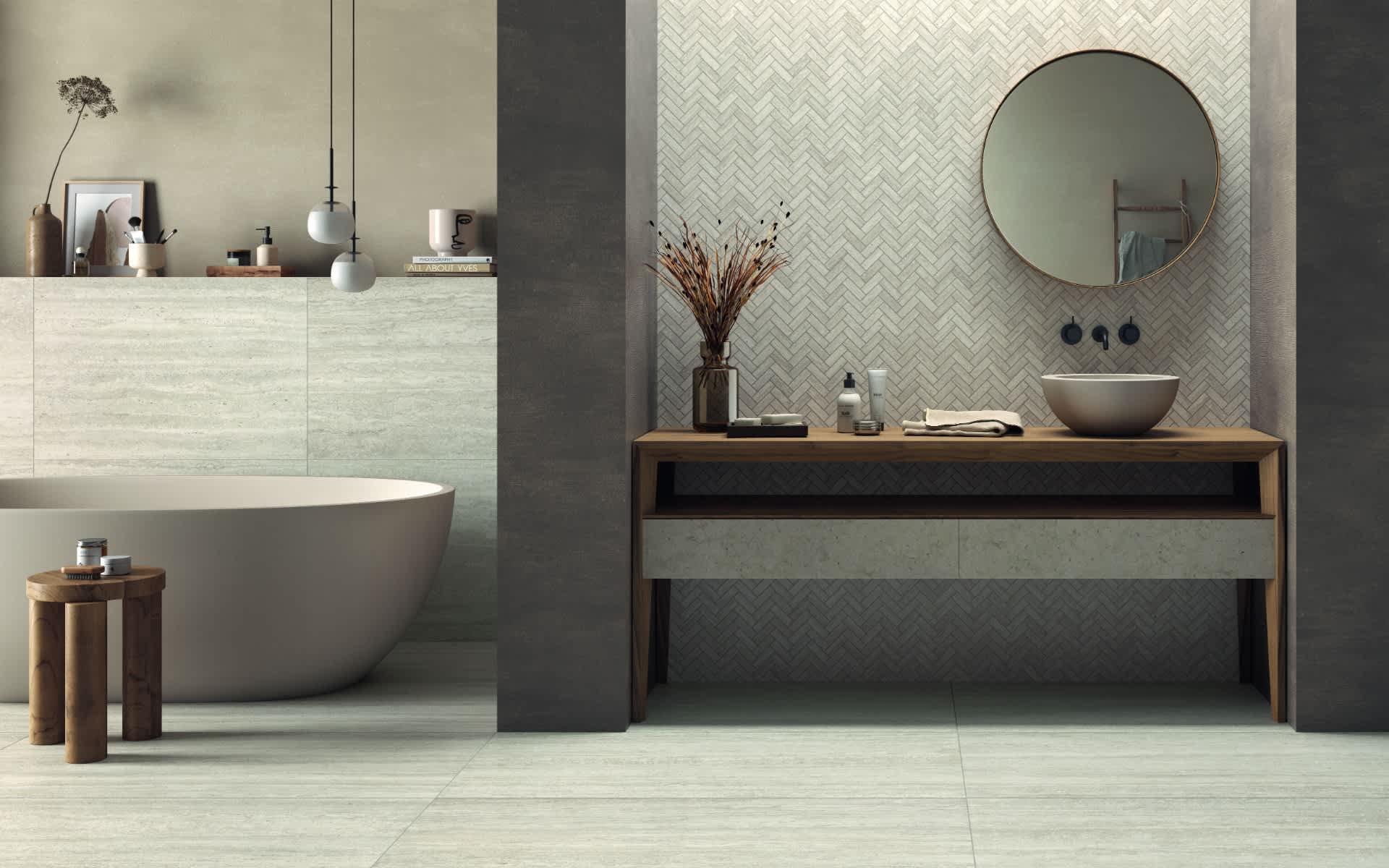 Castelvetro Firenze porcelain stoneware tiles in greige installed in luxury bathroom featuring vein cut wall tiles and herringbone mosaic pattern accent wall with freestanding white bathtub wooden vanity with open shelf round mirror and matte floor tiles