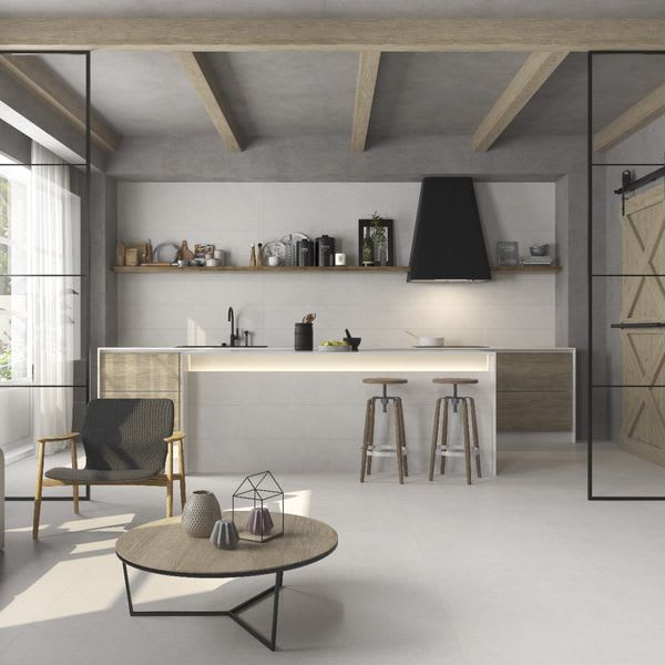 Argenta Gravel porcelain stoneware cream white floor tiles thumbnail showing modern kitchen with exposed wooden ceiling beams black range hood white island bar stools and open-plan living area