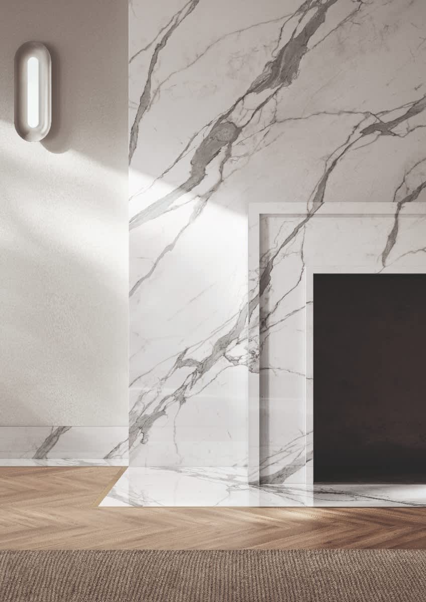 Italstone porcelain slab in Statuario Puro, bookmatched around a living-room fireplace with crisp grey veining on a bright white ground.