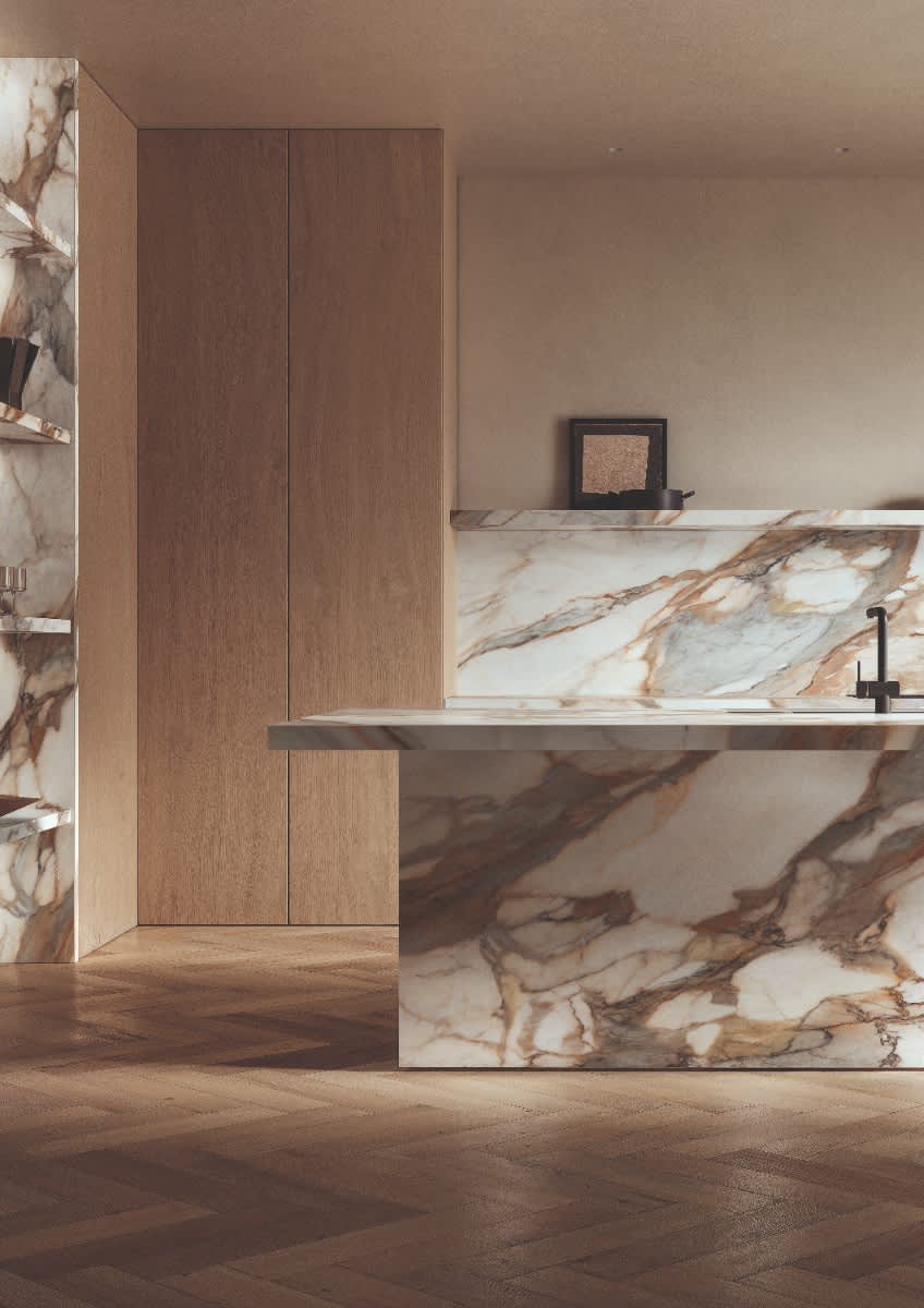 Italstone porcelain slab in Calacatta Antico, wrapping a kitchen island with dramatic gold and brown veining on warm white.