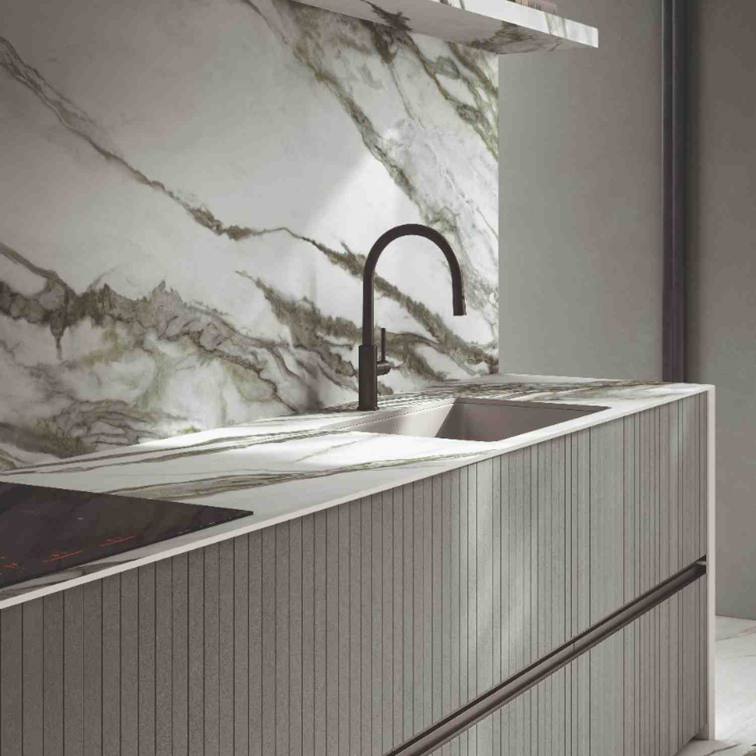 Italstone porcelain slab in Calacatta Green, installed as a kitchen backsplash and island with soft green veining on white marble.