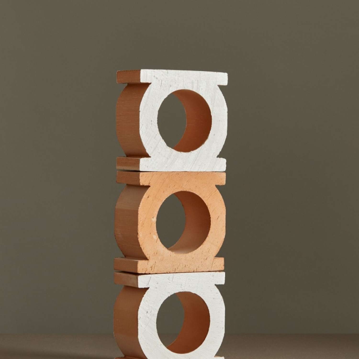 Mutina Jali 3D extruded terracotta blocks with circular openings stacked showing bianco white and neutro natural color variations against grey background