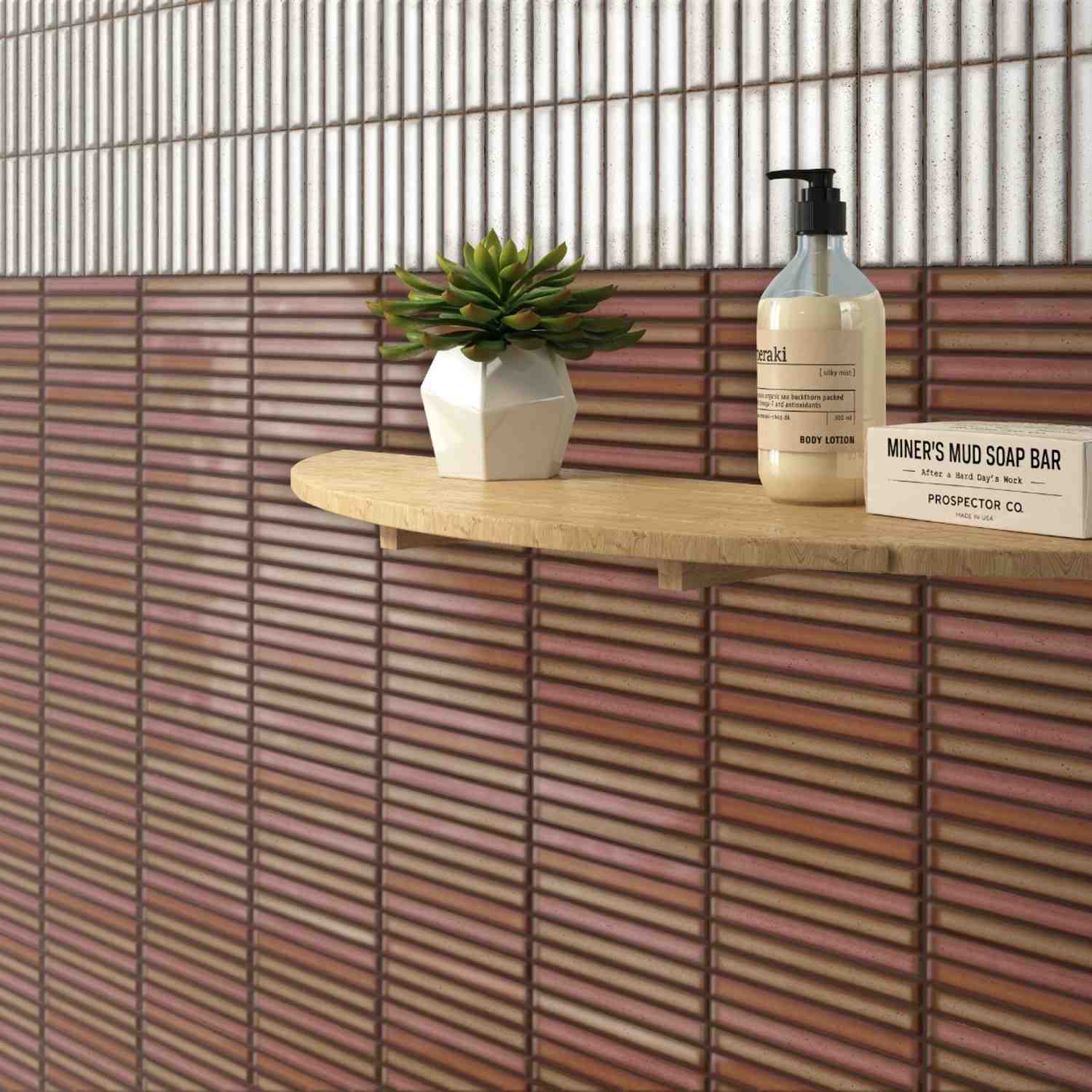Estudio Ceramico Karatsu glazed porcelain wall tiles in rusty red and polar white horizontal linear pattern with wooden shelf displaying succulent plant and bathroom accessories
