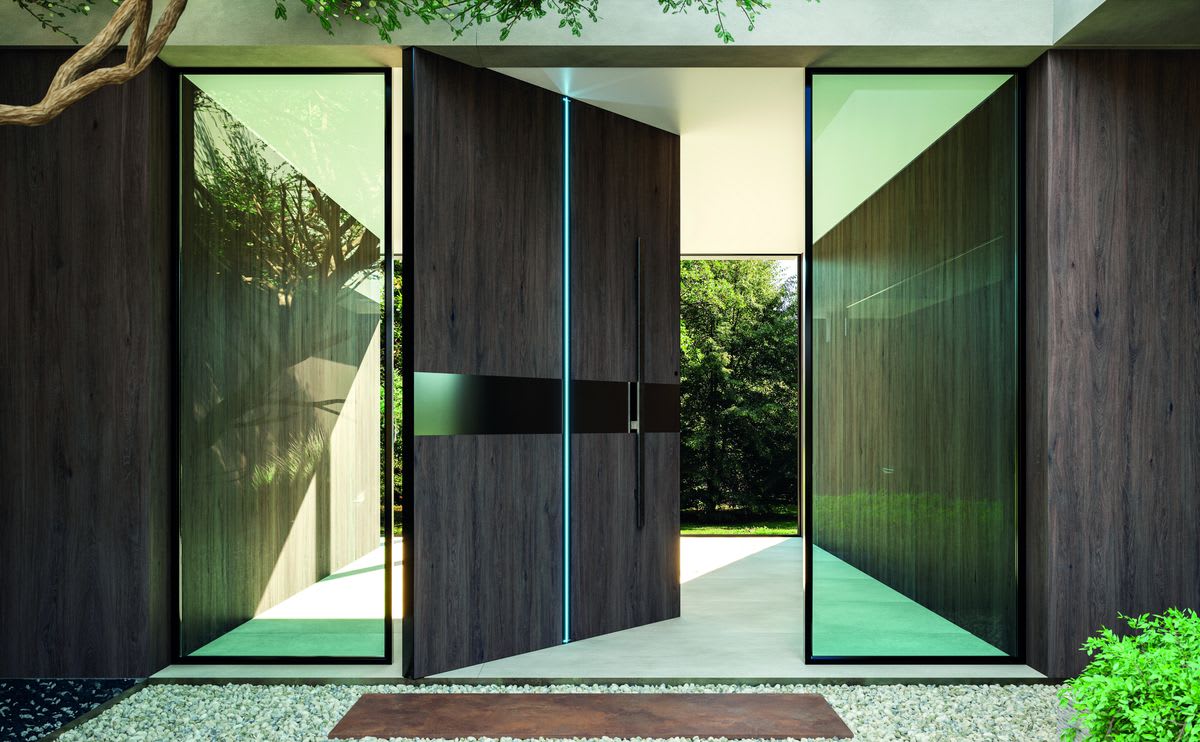 Laminam Ki No Bi porcelain slab in Acai as dark wood-look façade cladding and a pivot entry door in a modern home exterior with greenery