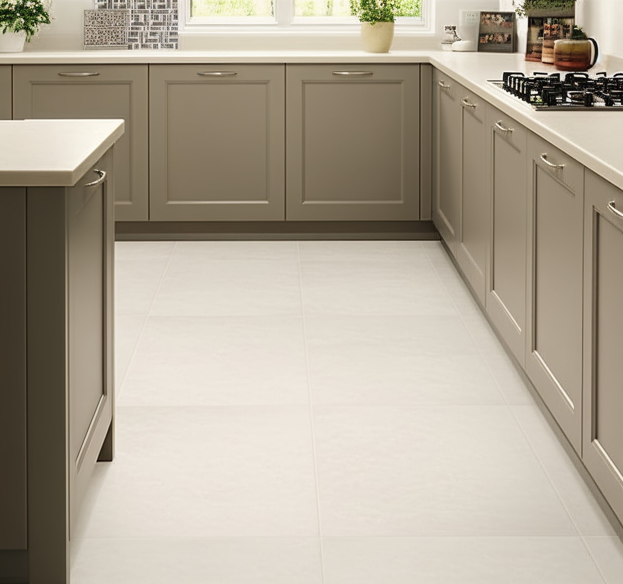 Overland Limestone ivory matte porcelain floor tiles in traditional kitchen with sage green shaker cabinetry, white countertops, and natural light from window