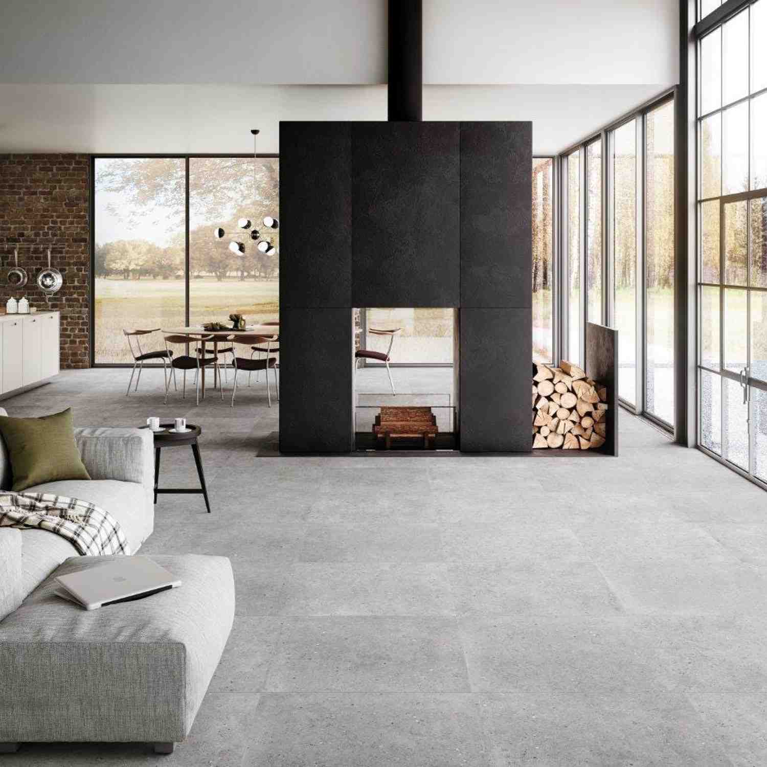 Refin Masterplan contemporary living space with light grey Mist porcelain floor tiles, dark Iron fireplace feature wall with firewood storage, floor-to-ceiling windows, dining area with brick accent wall