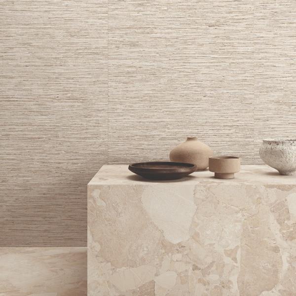 Ergon Matera Stone Ritmo beige textured wall tiles with stone block shelf displaying ceramic bowls and vase in earth tones