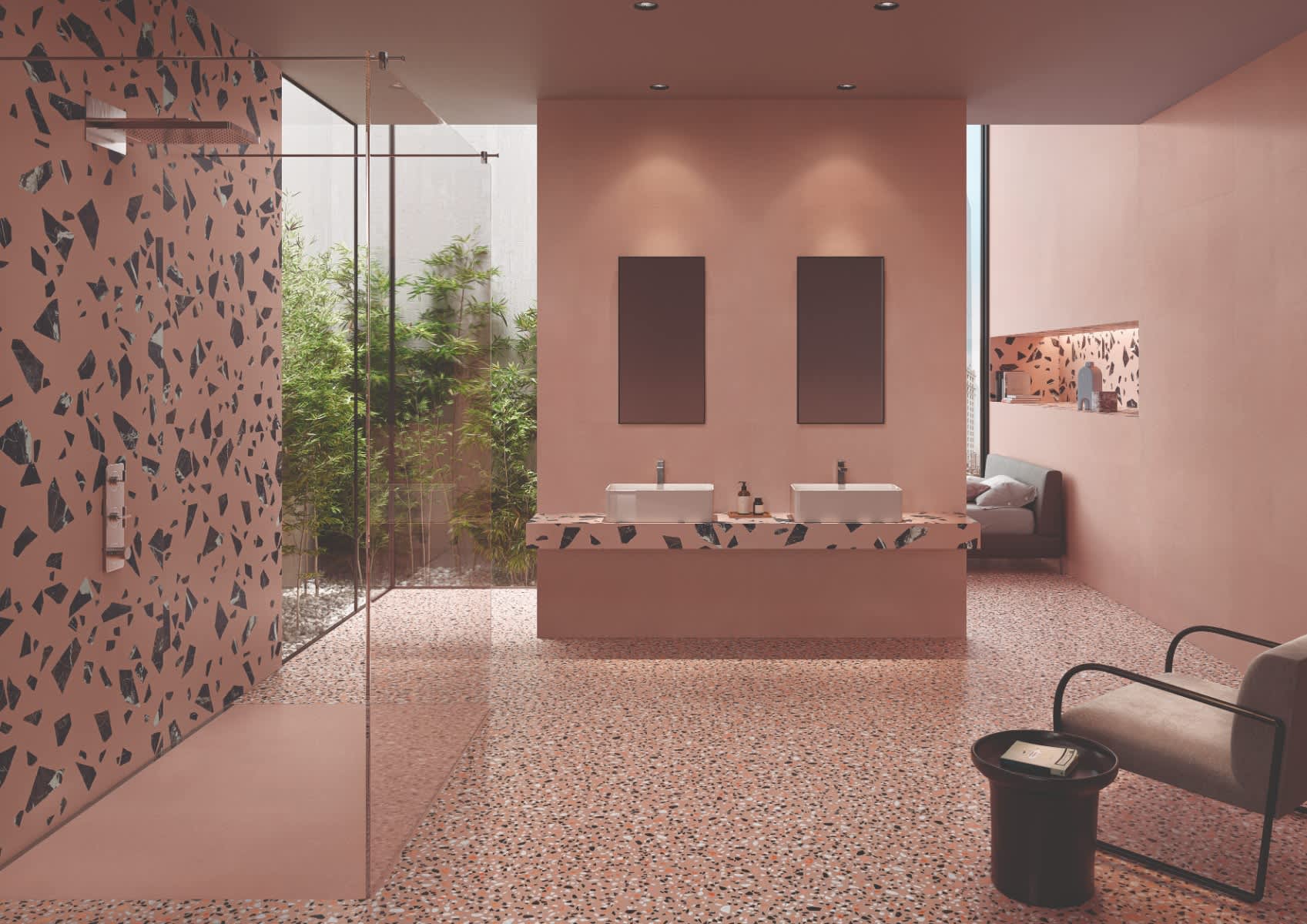 Emilceramica Medley Pink Minimal walls with Pop Pink terrazzo mosaic shower wall and floor tiles in a contemporary bathroom with dual vessel sinks, glass shower enclosure, indoor bamboo plants, and dark artwork panels