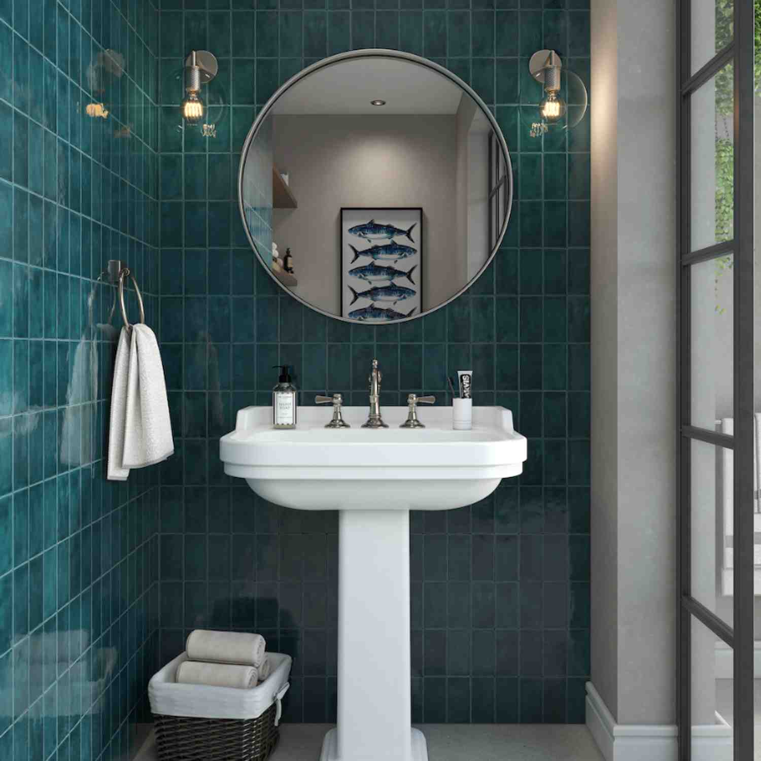 Terratinta Memorie Muschio deep teal glossy ceramic wall tiles in bathroom with white pedestal sink, round mirror, brass sconces, fish artwork, and steel-framed window