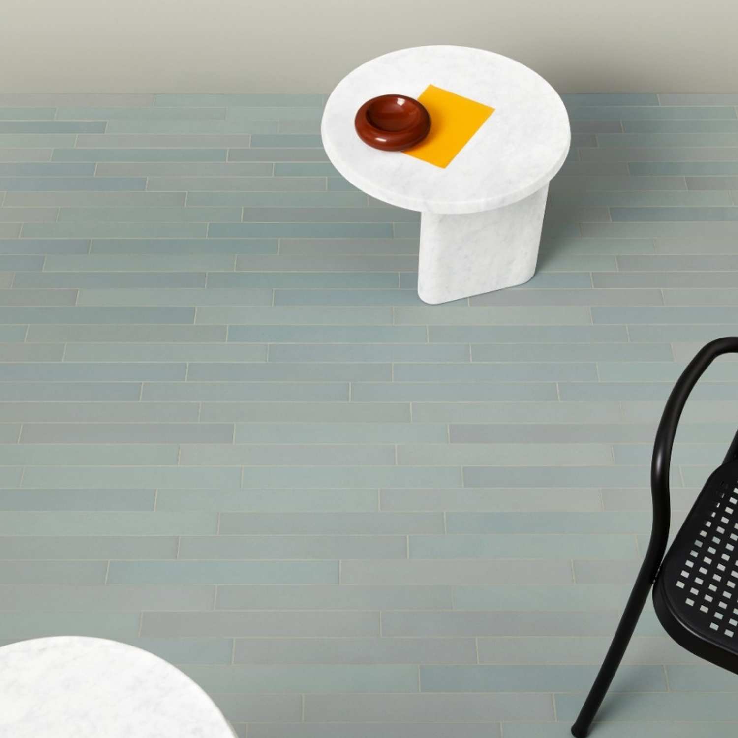Mutina Mews Light Blue matte porcelain floor tiles in stacked bond pattern with white marble side table and minimalist accessories
