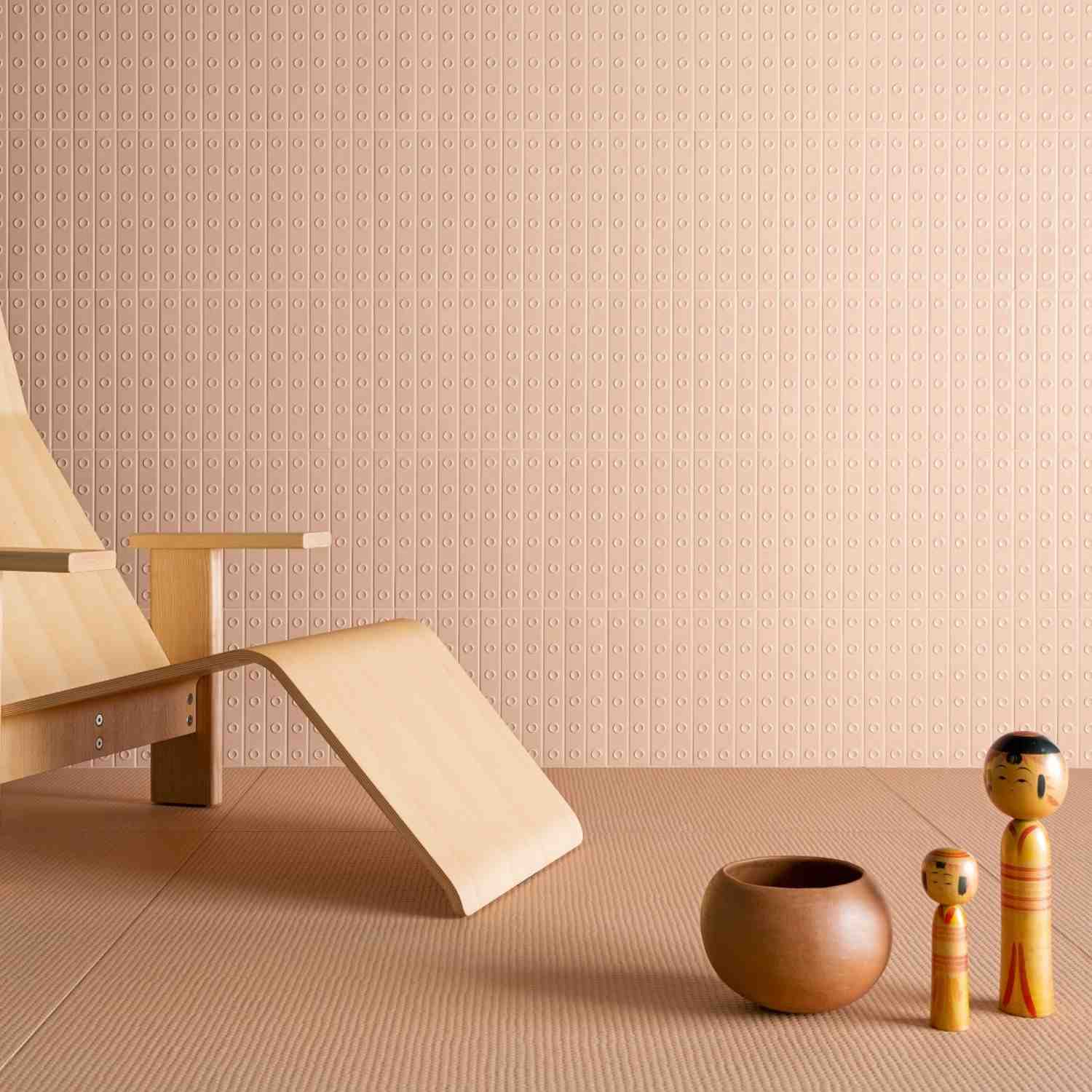 Mutina Punto glazed ceramic wall tiles in Rose pink with raised dot texture pattern, full wall installation with wooden bench and gold decorative sphere accent