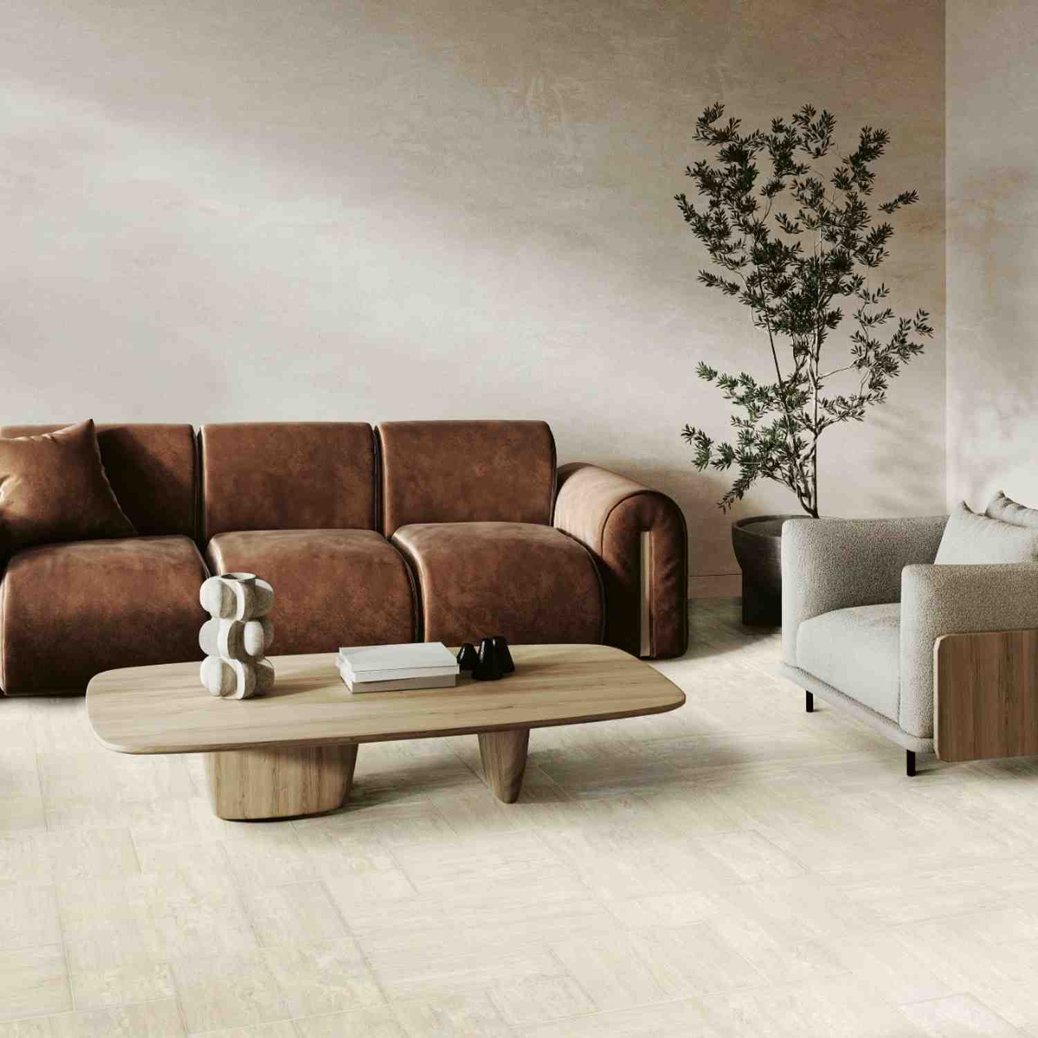 Ceramica Fioranese Senzatempo Trav porcelain stoneware tiles in Beige travertine-look on living room wall featuring brown leather sofa, wooden oval coffee table with decorative objects, tall olive tree plant, and light cream armchair in warm contemporary
