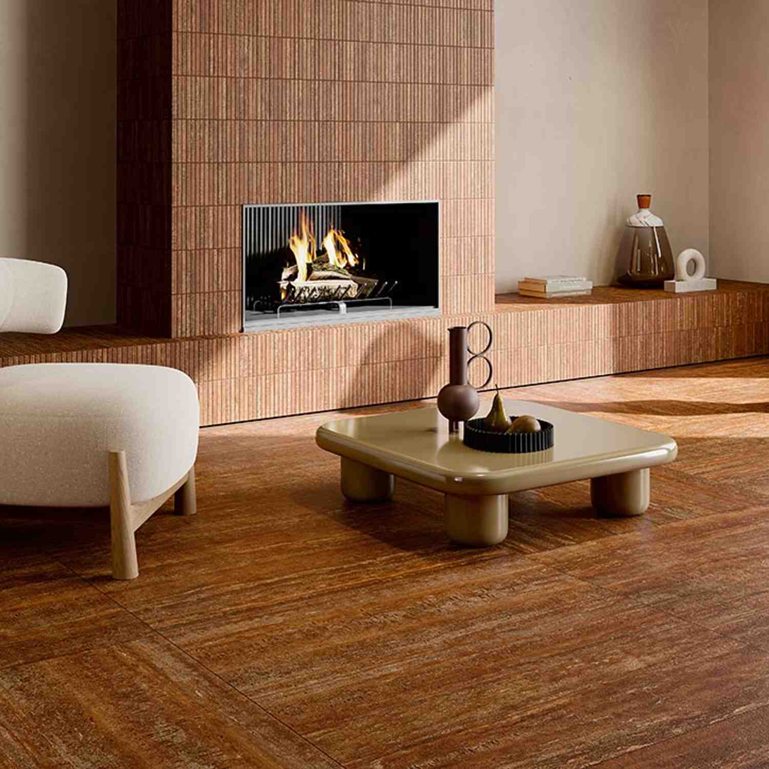 Ceramica Fioranese Senzatempo Trav porcelain stoneware tiles in Beige travertine-look covering fireplace wall with built-in modern fireplace, low coffee table, white curved sofa, and decorative objects on wooden shelf