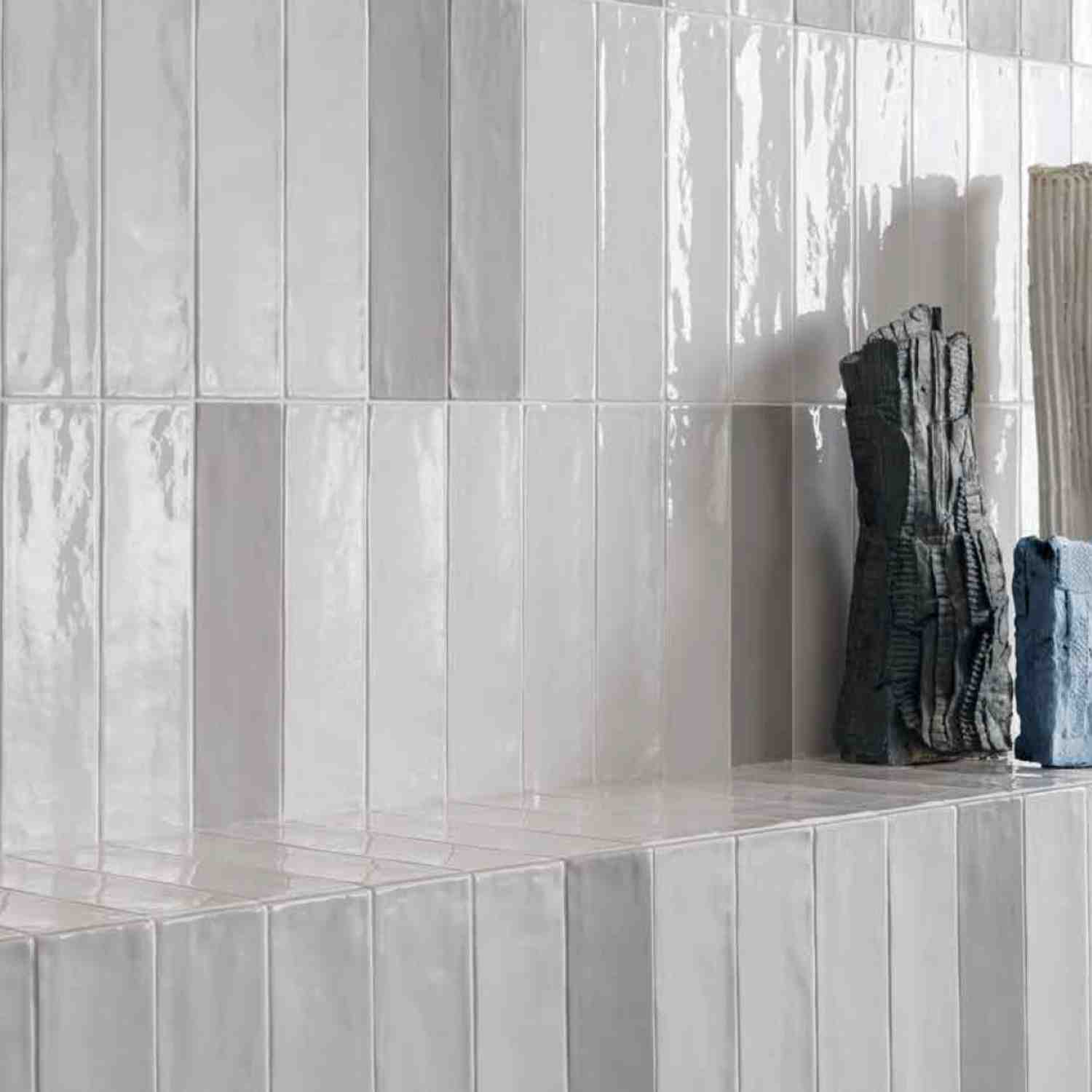 Ergon Total Brick glazed ceramic wall tiles in white with glossy finish showing brick format detail with built-in shelf niche and hanging towels