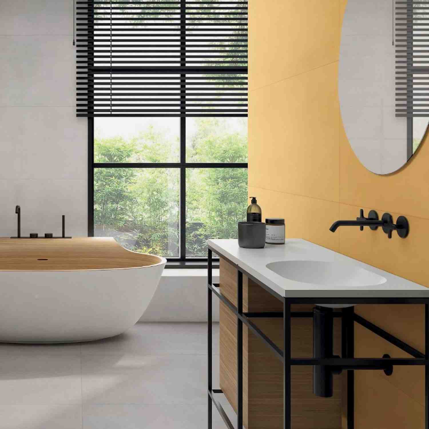 Florina Urban Cement porcelain wall tiles in warm ochre yellow in a modern bathroom with freestanding bathtub, wooden vanity, matte black fixtures, and louvered windows