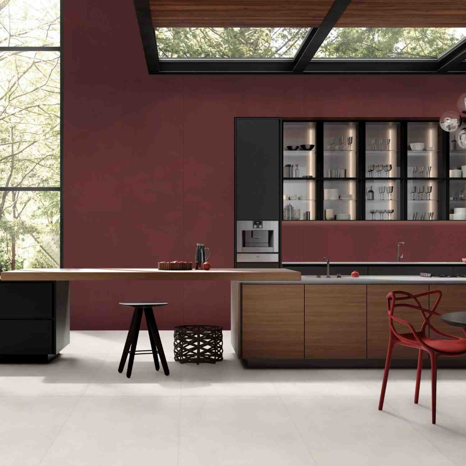 Florina Urban Cement porcelain wall tiles in deep burgundy red in a modern kitchen with wooden cabinetry, glass-front upper cabinets, red accent chair, and industrial windows