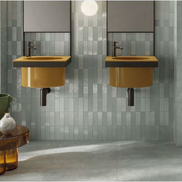 Sixty sage green porcelain wall tile bathroom with dual mustard sinks and gray floor tile