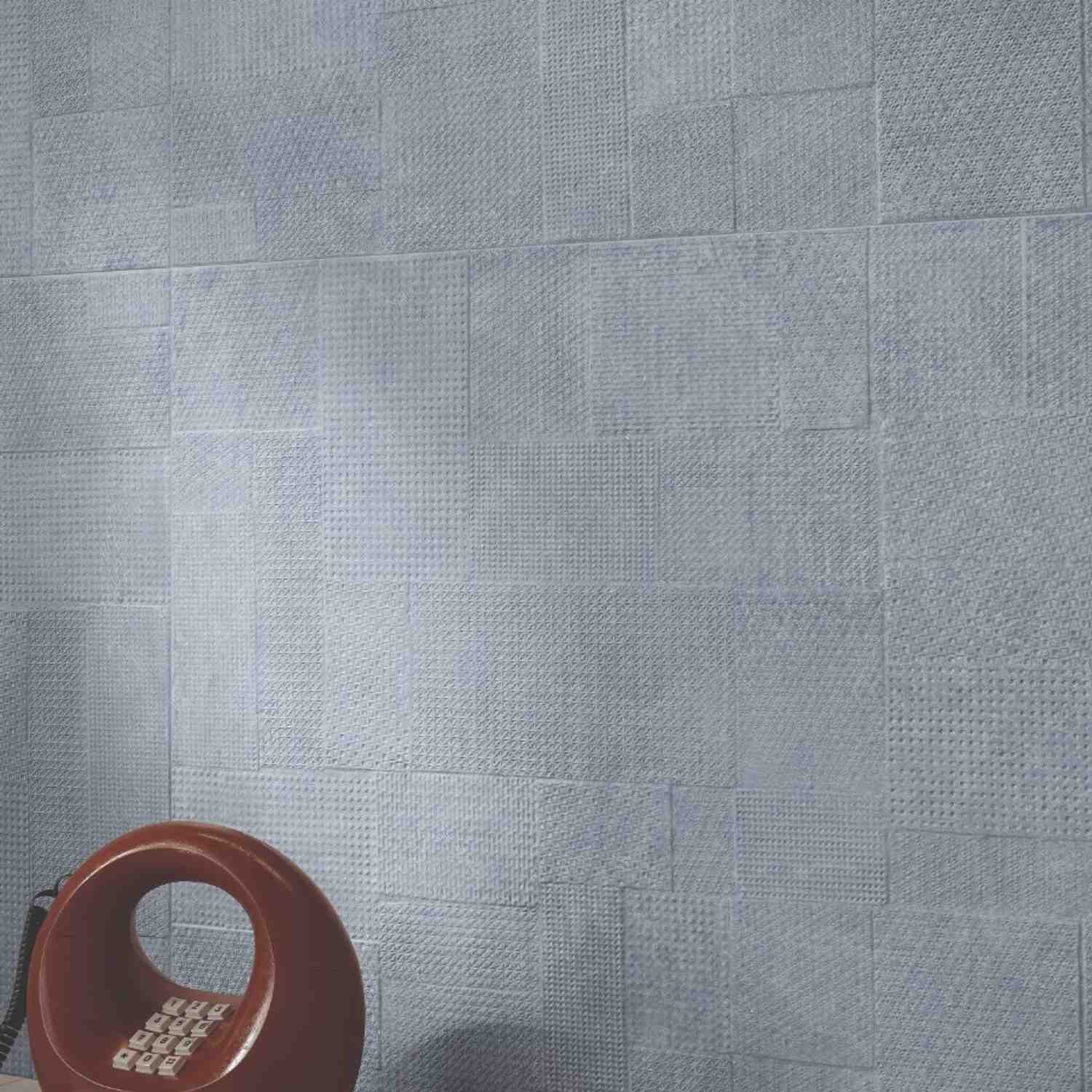 Sixty textured porcelain wall tile close-up showing cross-hatch pattern with terracotta vase accent