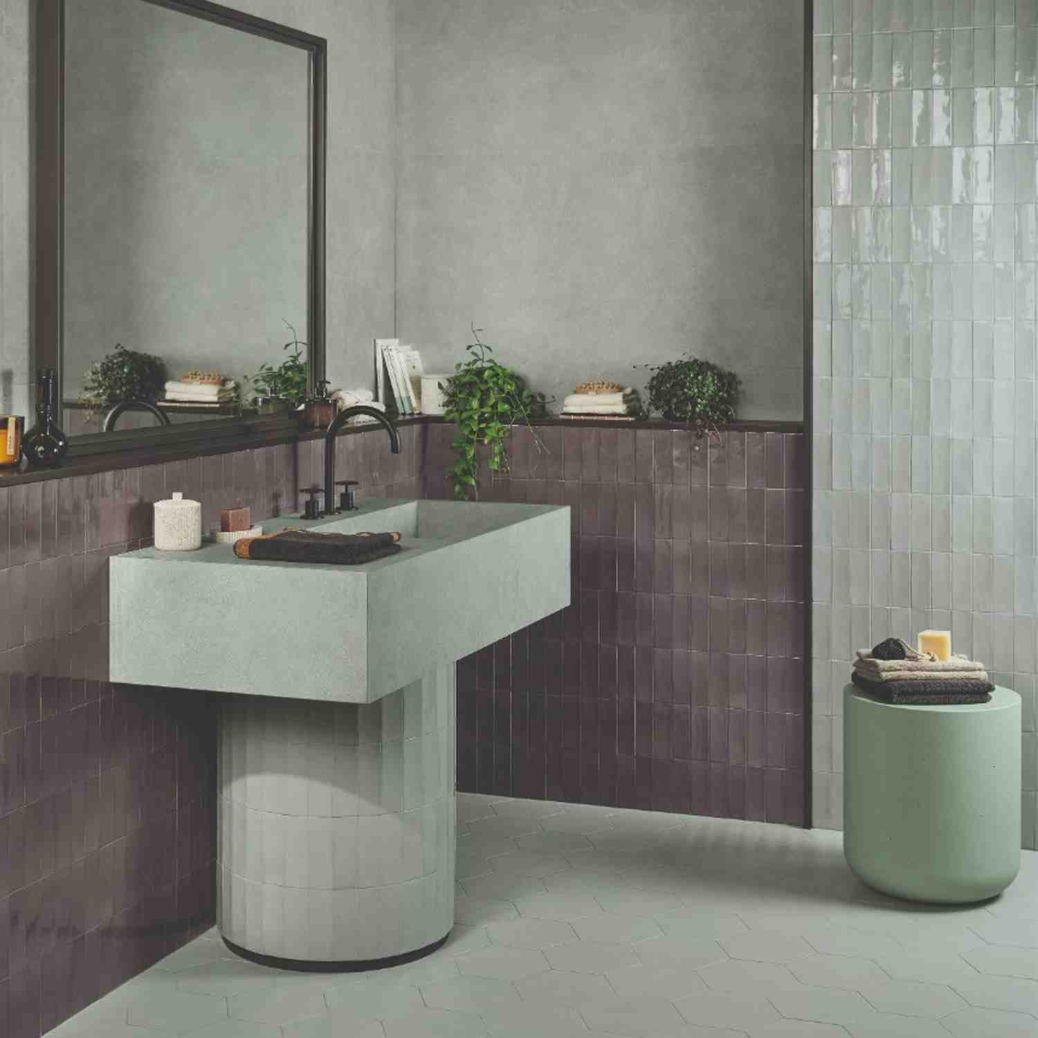 Sixty mauve porcelain wall tiles with sage green accents in modern bathroom with vanity and plants