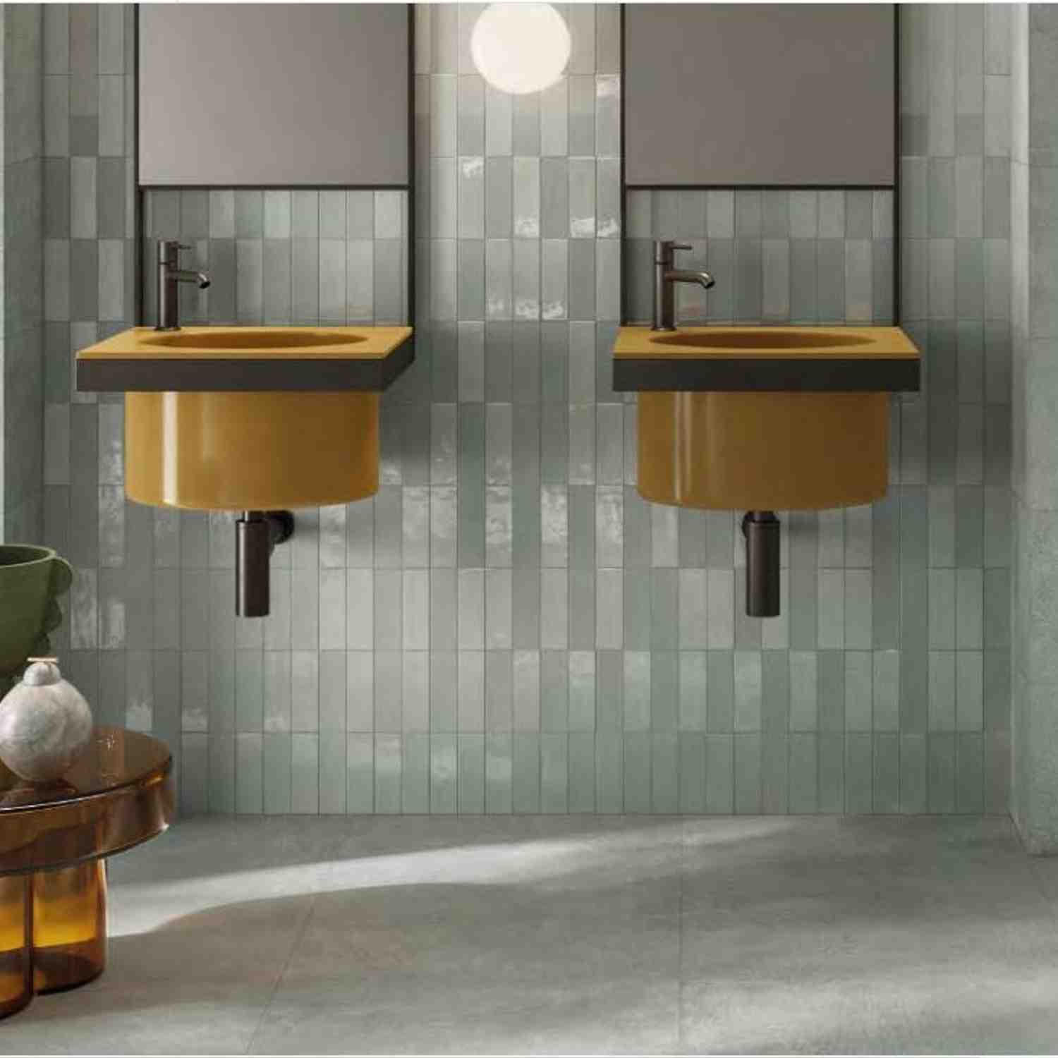 Sixty sage green vertical porcelain wall tiles in bathroom with mustard yellow wall-mounted sinks