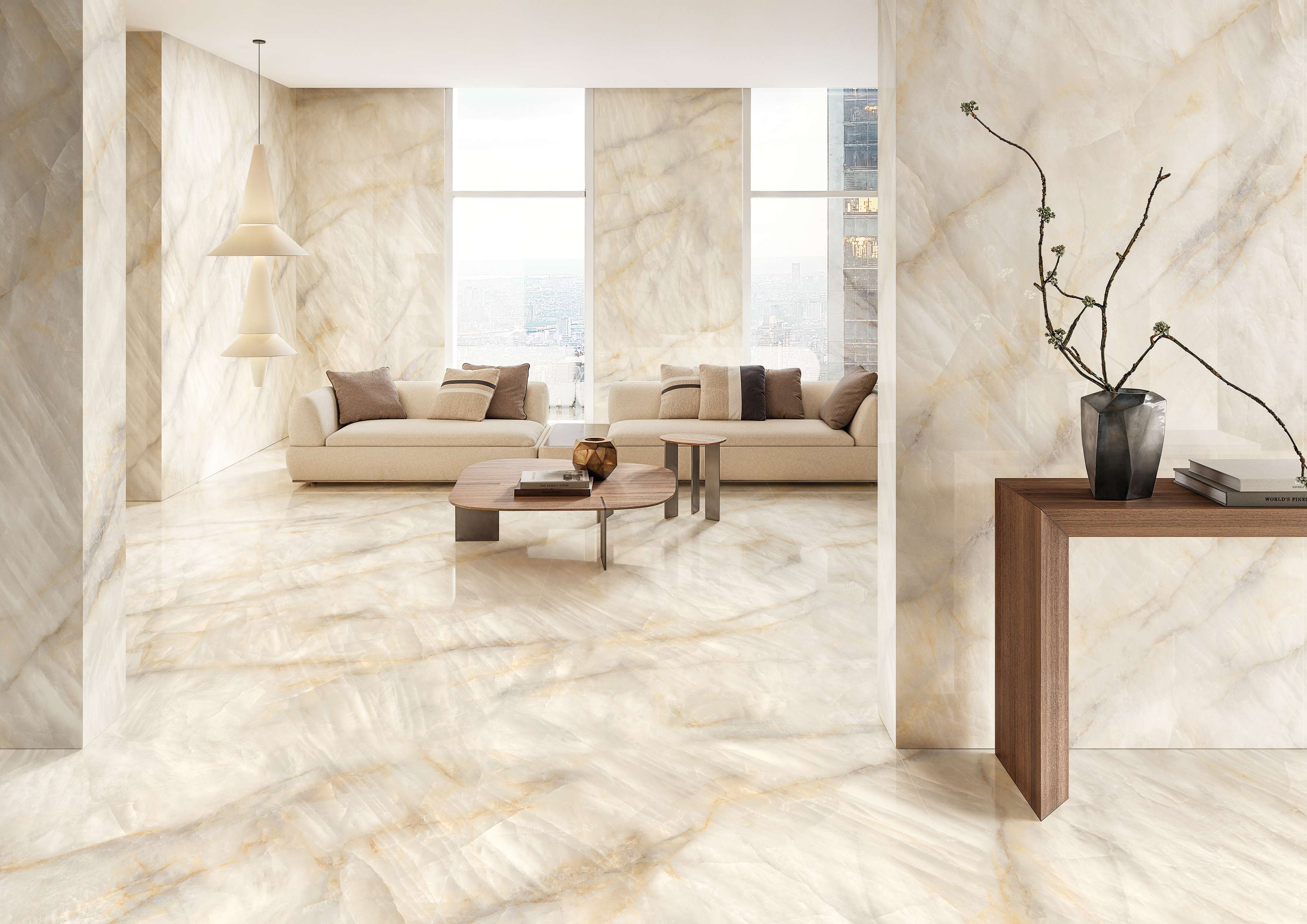 Tele di Marmo Crystal porcelain tile in Extra Ivory installed as floor and walls in a bright high-rise living room with pale sofas